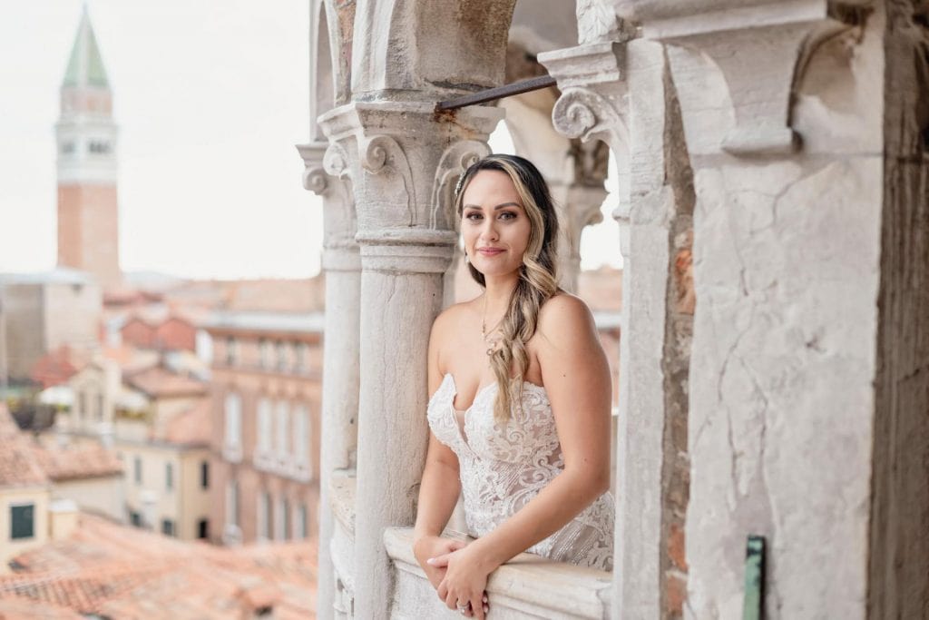 Bride and groom pose on the spiral staircase of Scala Contarini del Bovolo in Venice.