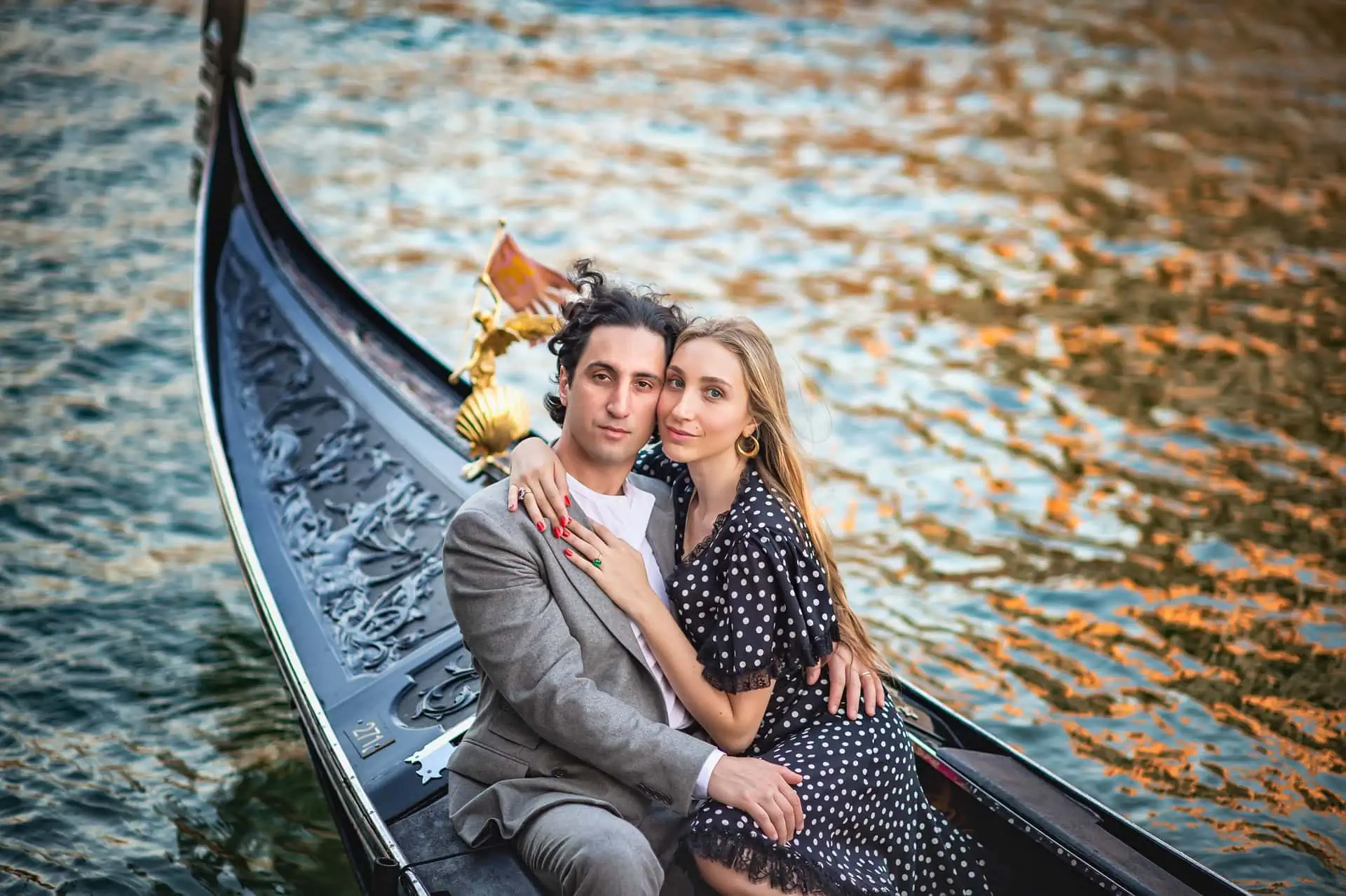 A couple during a symbolic wedding in Venice captured in a romantic gondola ride on the Grand Canal.