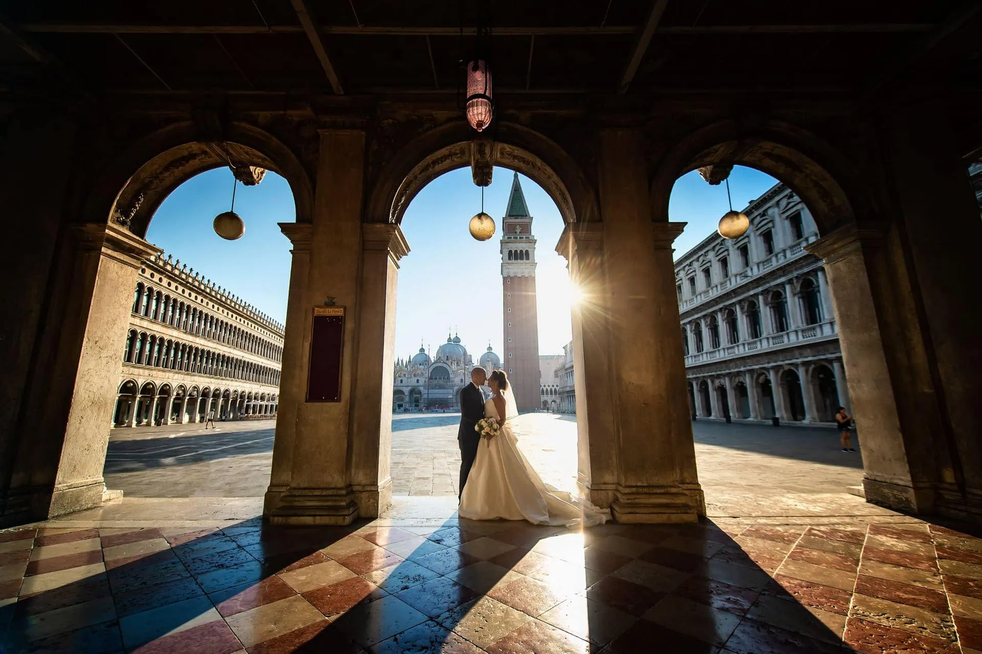 A couple during a symbolic wedding in Venice captured in the iconic Piazza San Marco, surrounded by its majestic architecture.