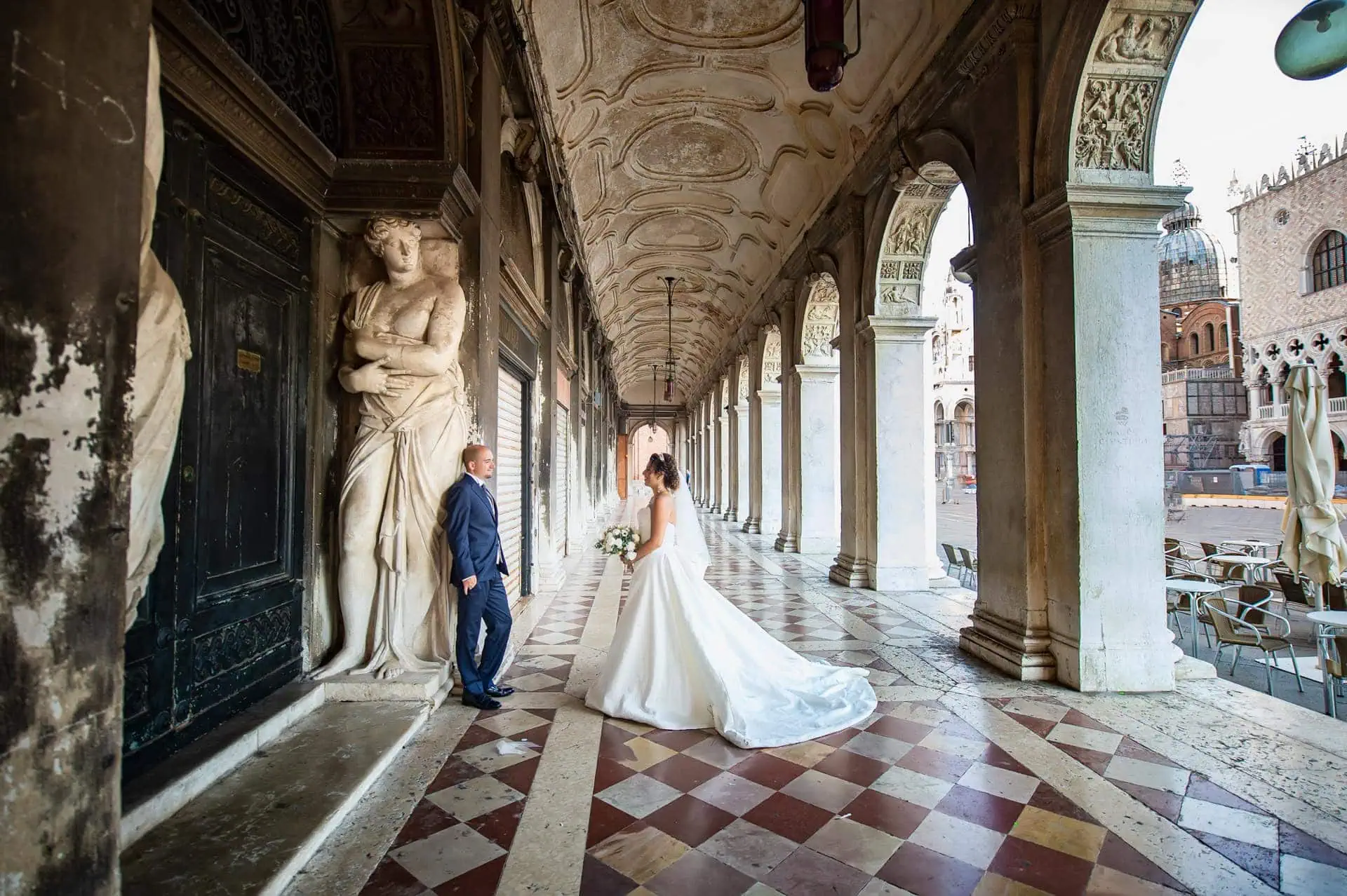 A couple during a symbolic wedding in Venice captured in the iconic Piazza San Marco, surrounded by its majestic architecture.