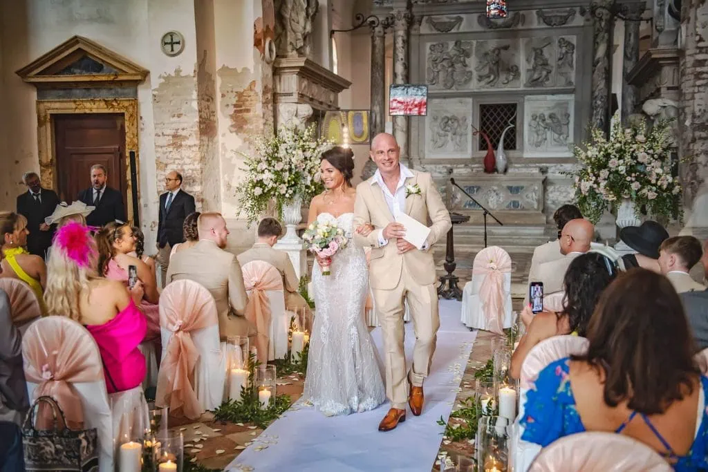 A couple during a symbolic wedding in Venice captured in a beautiful historic church.