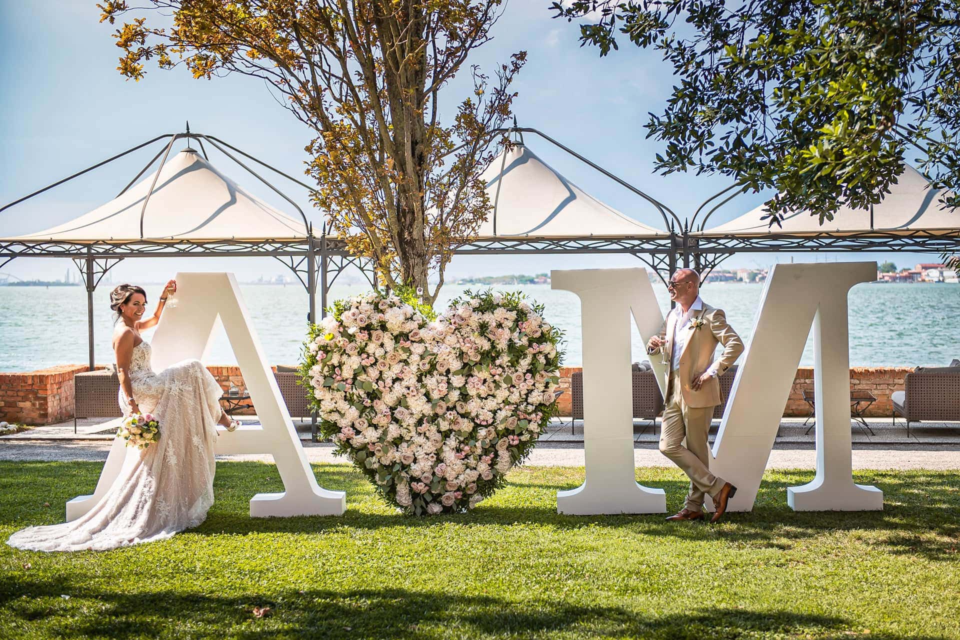 A couple during a symbolic wedding in Venice captured in the enchanting gardens of the Kempinski Hotel.