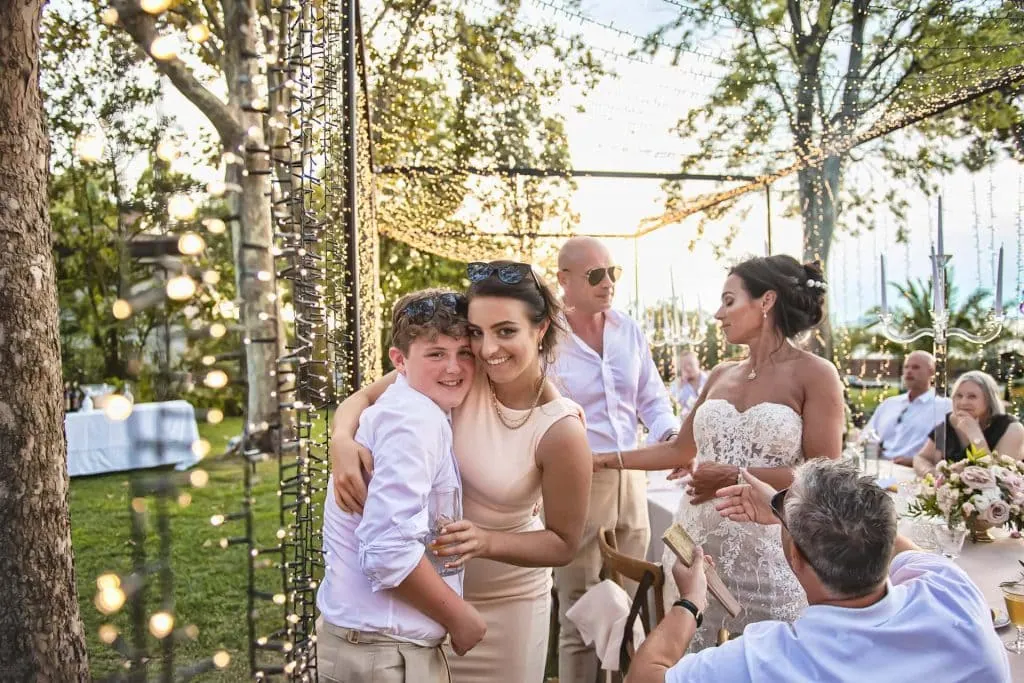 A couple during a symbolic wedding in Venice captured in the enchanting gardens of the Kempinski Hotel.