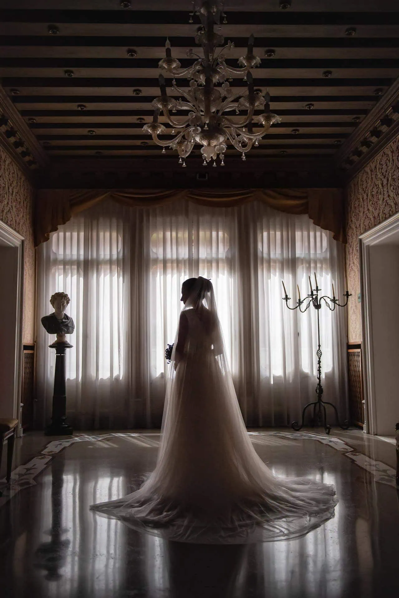 A couple during a symbolic wedding in Venice captured in the lush garden of a private palace.
