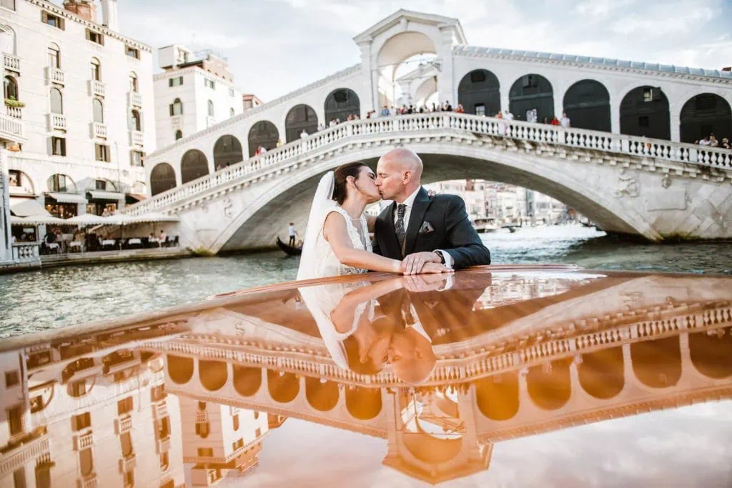 A couple during a symbolic wedding in Venice captured on a water taxi cruising along the Grand Canal.