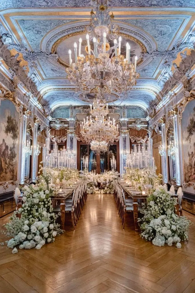 A couple during a symbolic wedding in Venice captured inside a luxurious private palace, surrounded by elegant decor.