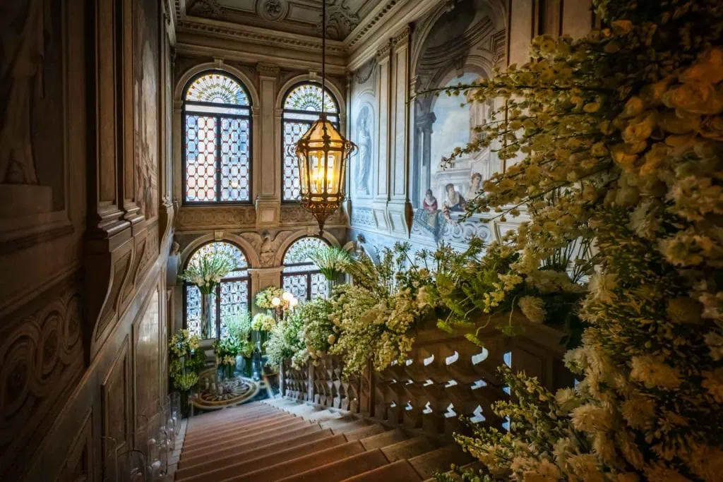 A couple during a symbolic wedding in Venice captured inside a luxurious private palace, surrounded by elegant decor.