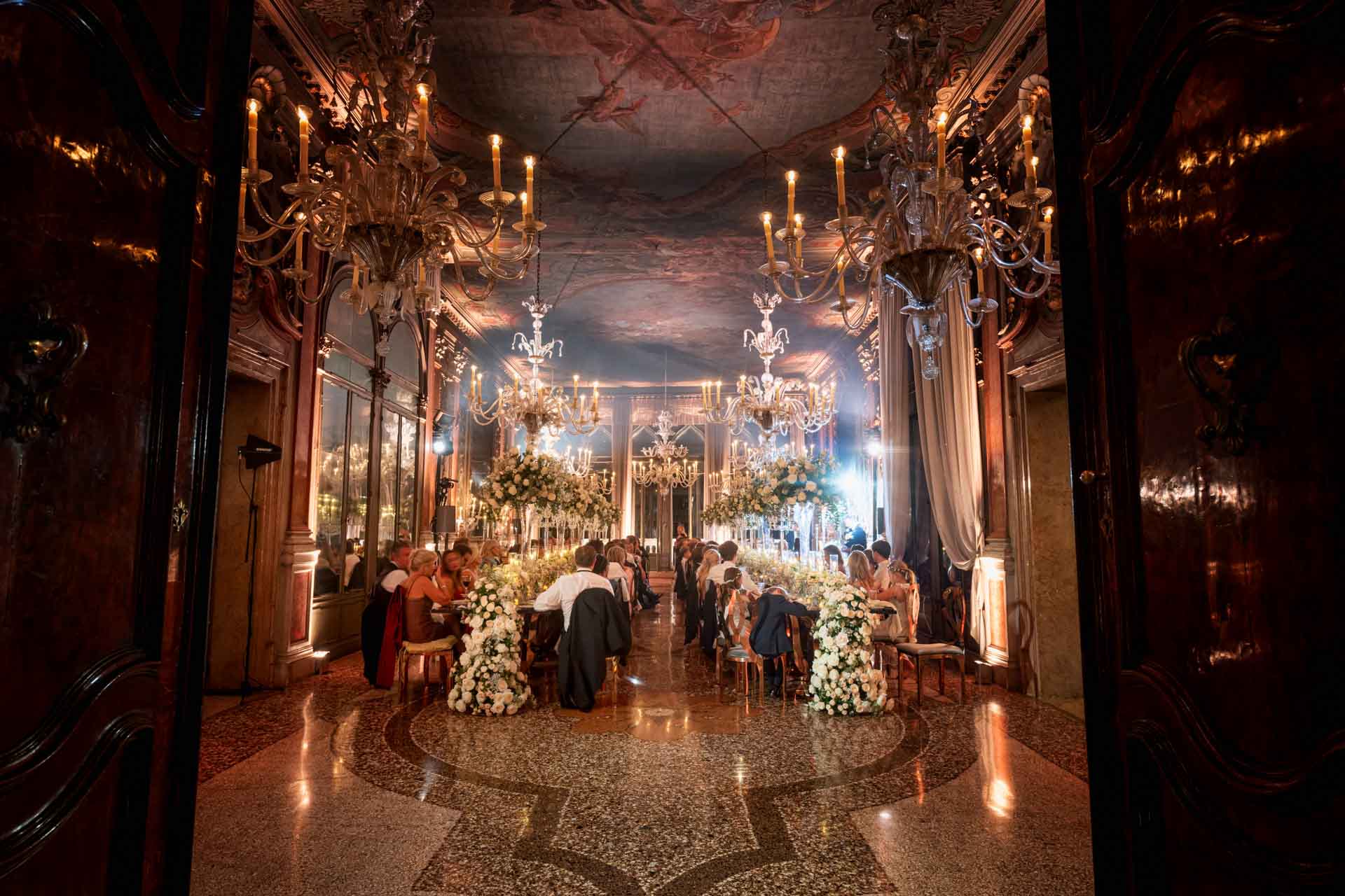 A couple during a symbolic wedding in Venice captured inside the historic Pisani Moretta palace.