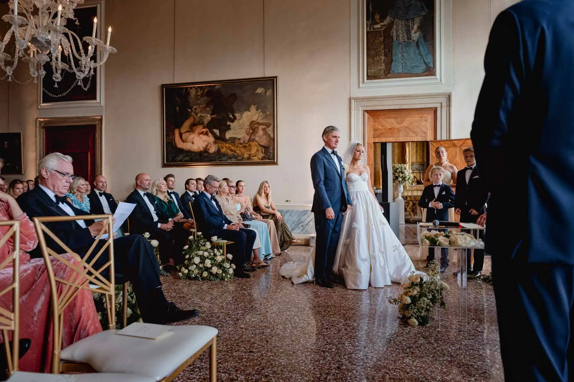 A couple during a symbolic wedding in Venice captured inside the historic Pisani Moretta palace.