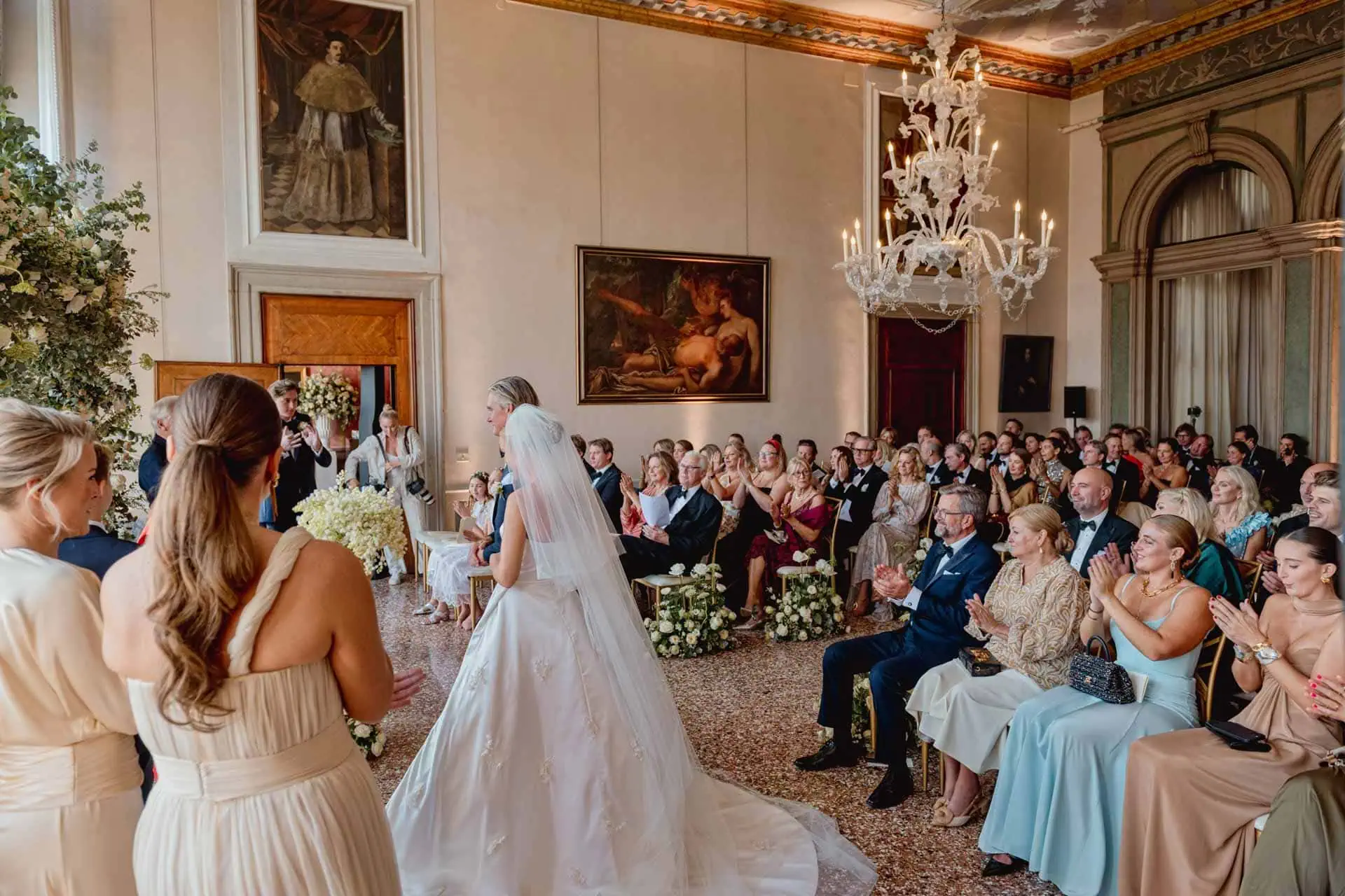A couple during a symbolic wedding in Venice captured inside the historic Pisani Moretta palace.