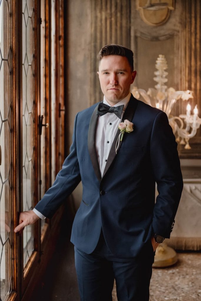 Bride posing gracefully in a Venetian palace before the wedding ceremony.