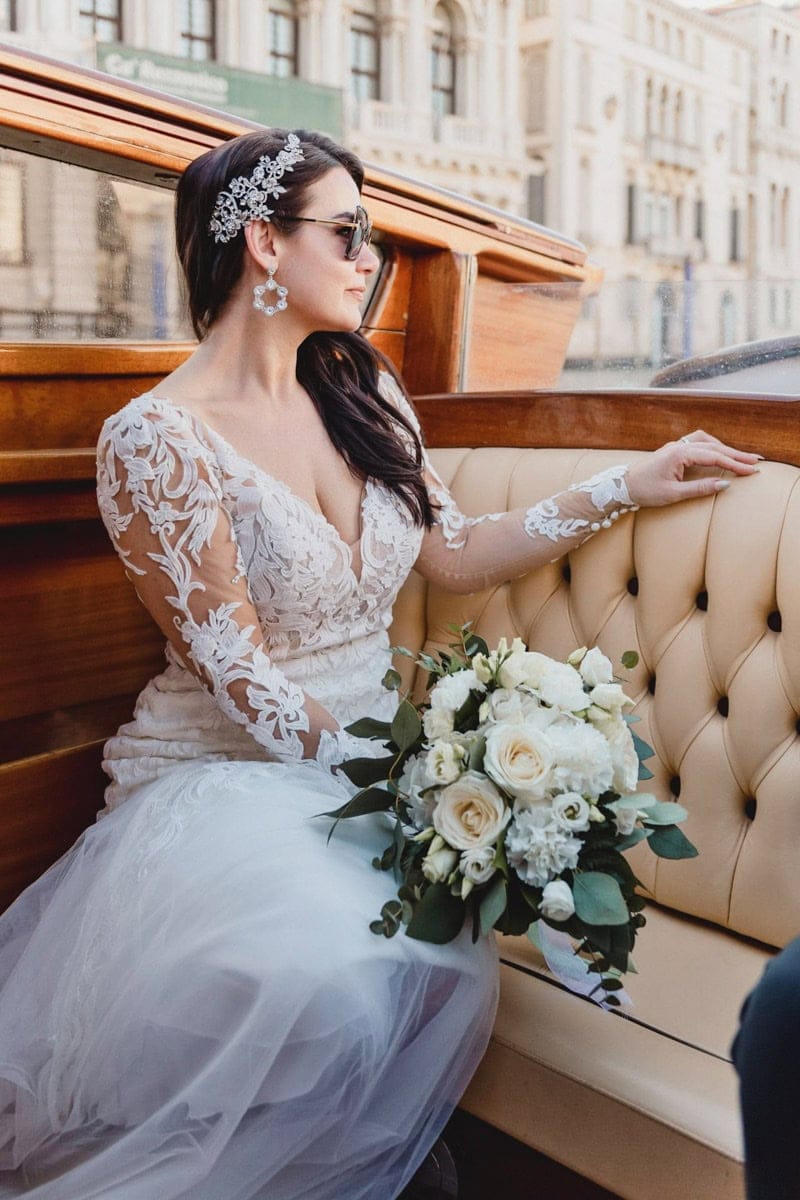 Elegant bride looking at the sunset over the Grand Canal – Magical Venice elopement moment.