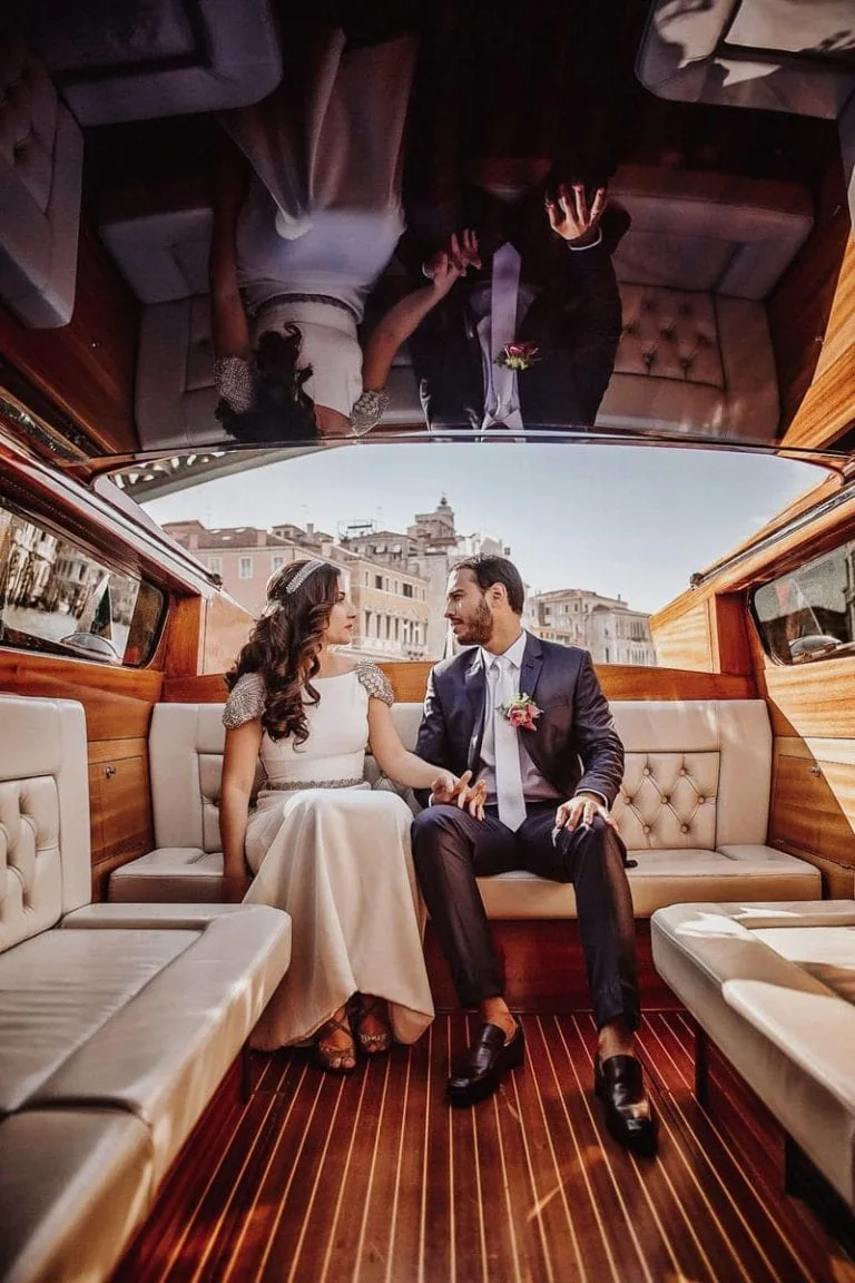 Bride and groom embracing on a hidden Venetian canal – Secret and romantic elopement in Venice.