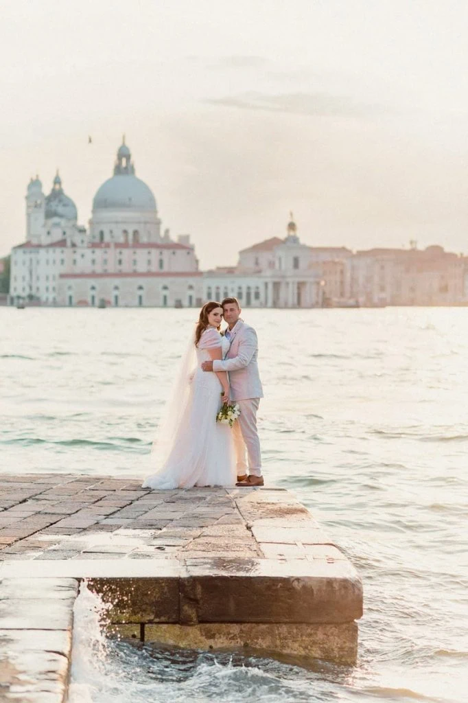 Bride and groom embracing on a hidden Venetian canal – Secret and romantic elopement in Venice.