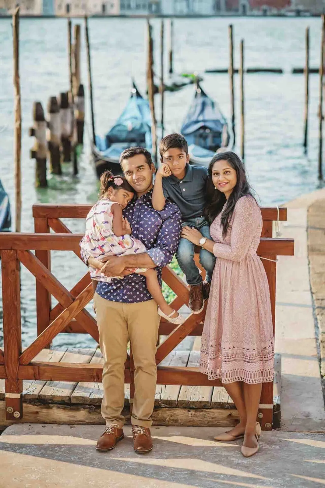 A family standing by the Grand Canal, enjoying the stunning Venice skyline.