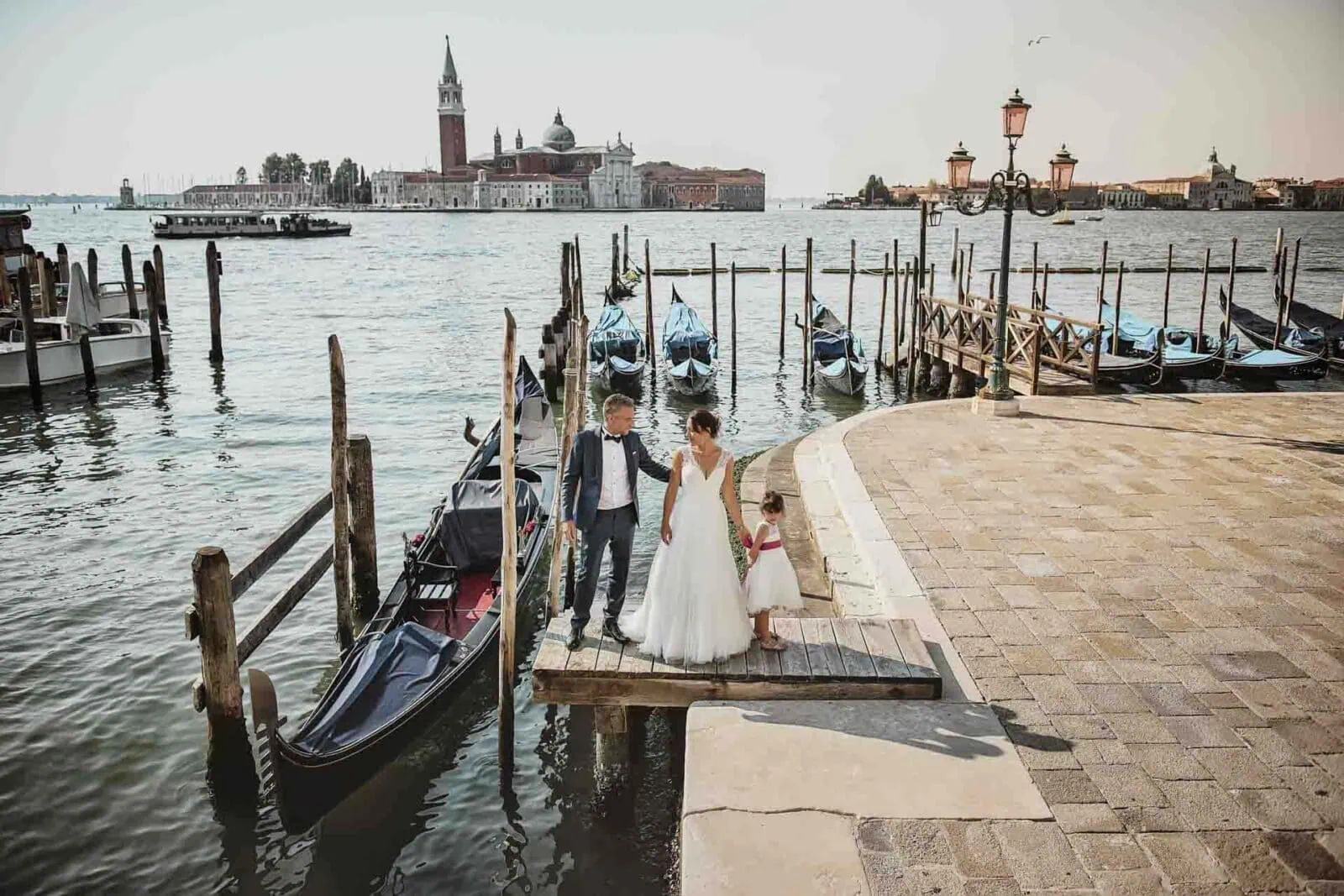 Family enjoying a scenic gondola ride through the canals of Venice.