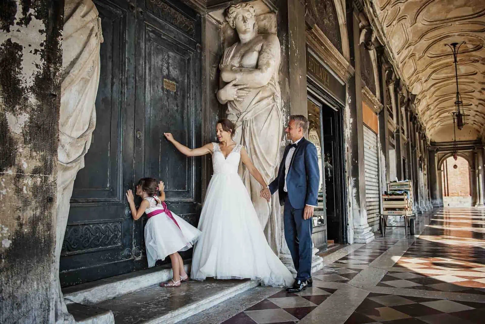 Parents with their daughter under the historic porticoes of the Doge’s Palace in Venice.