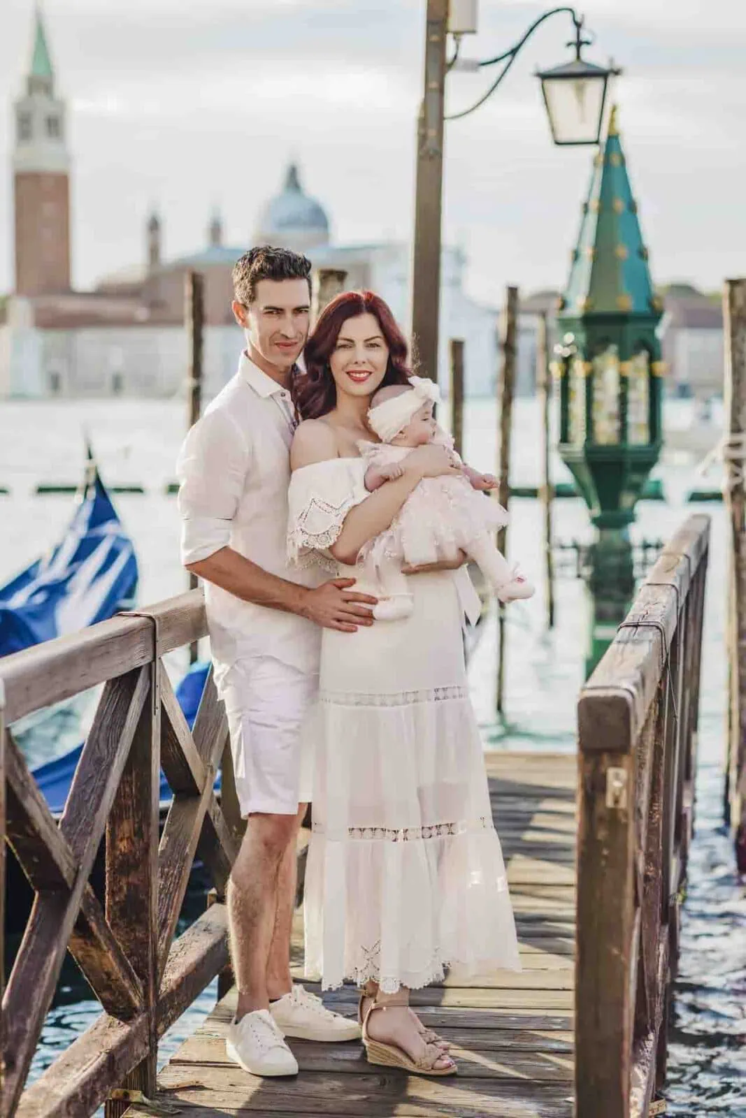 A family standing by the Grand Canal, enjoying the stunning Venice skyline.