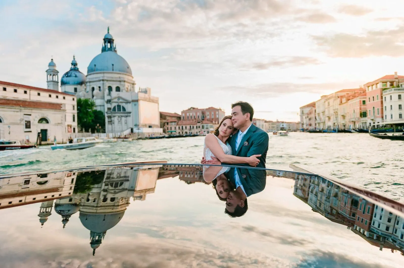 Engagement photos in Venice featuring a couple in a water taxi at sunset.