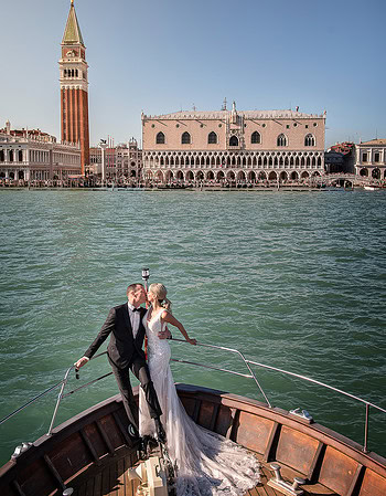 Elegant couple on a boat in Venice with historic architecture and calm waters, capturing a romantic.