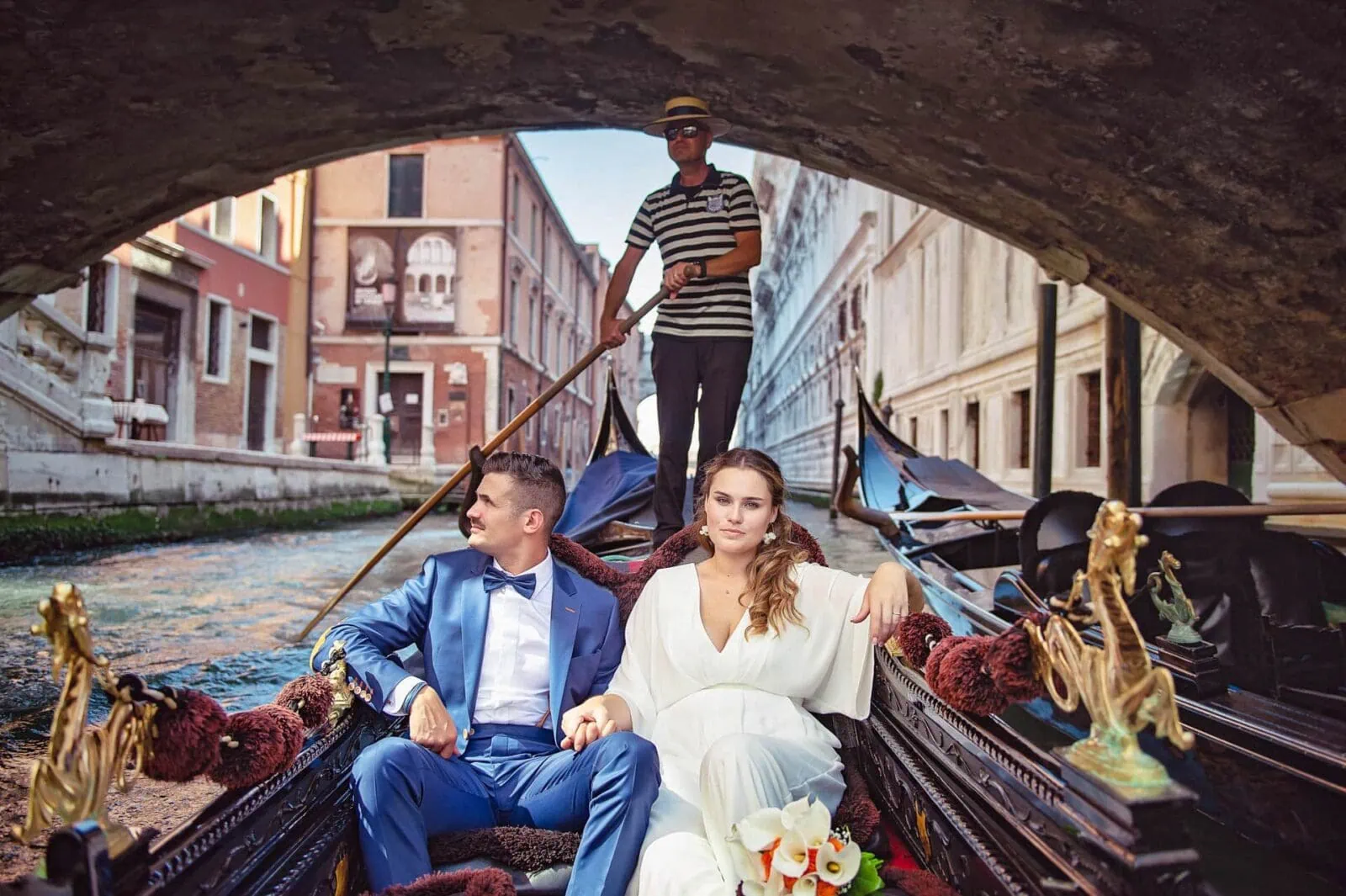 Romantic couple enjoying their honeymoon in Venice, Italy, captured in a scenic Venetian backdrop with historic canals, gondolas, and iconic landmarks.