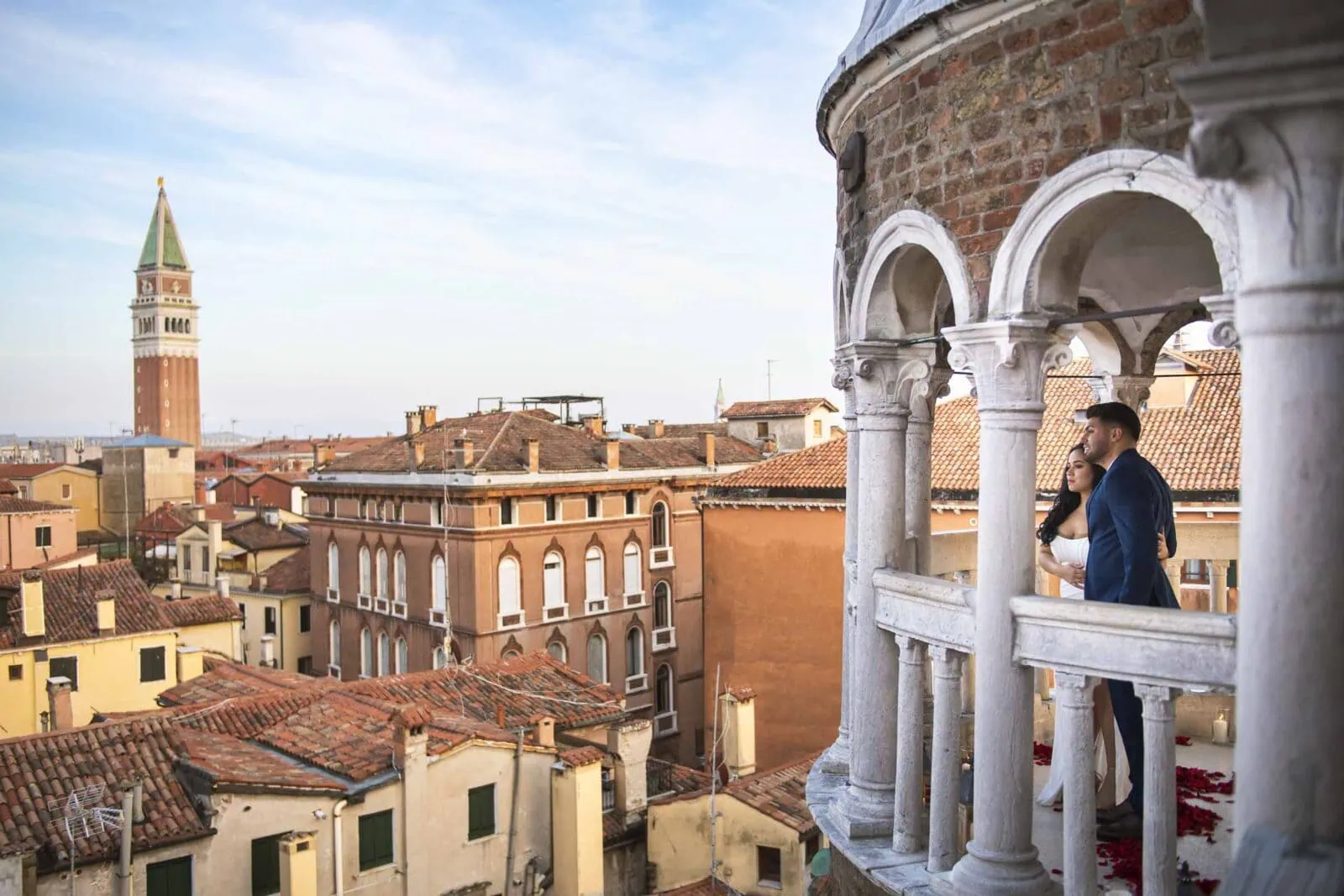 Romantic couple enjoying their honeymoon in Venice, Italy, captured in a scenic Venetian backdrop with historic canals, gondolas, and iconic landmarks.