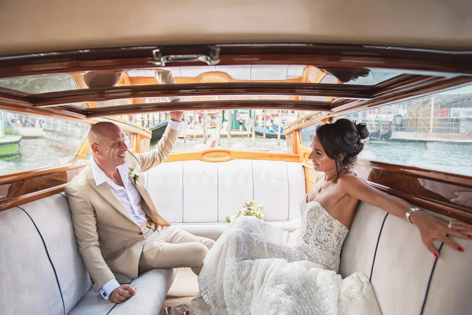 Bride and groom arriving in a private water taxi in Venice.