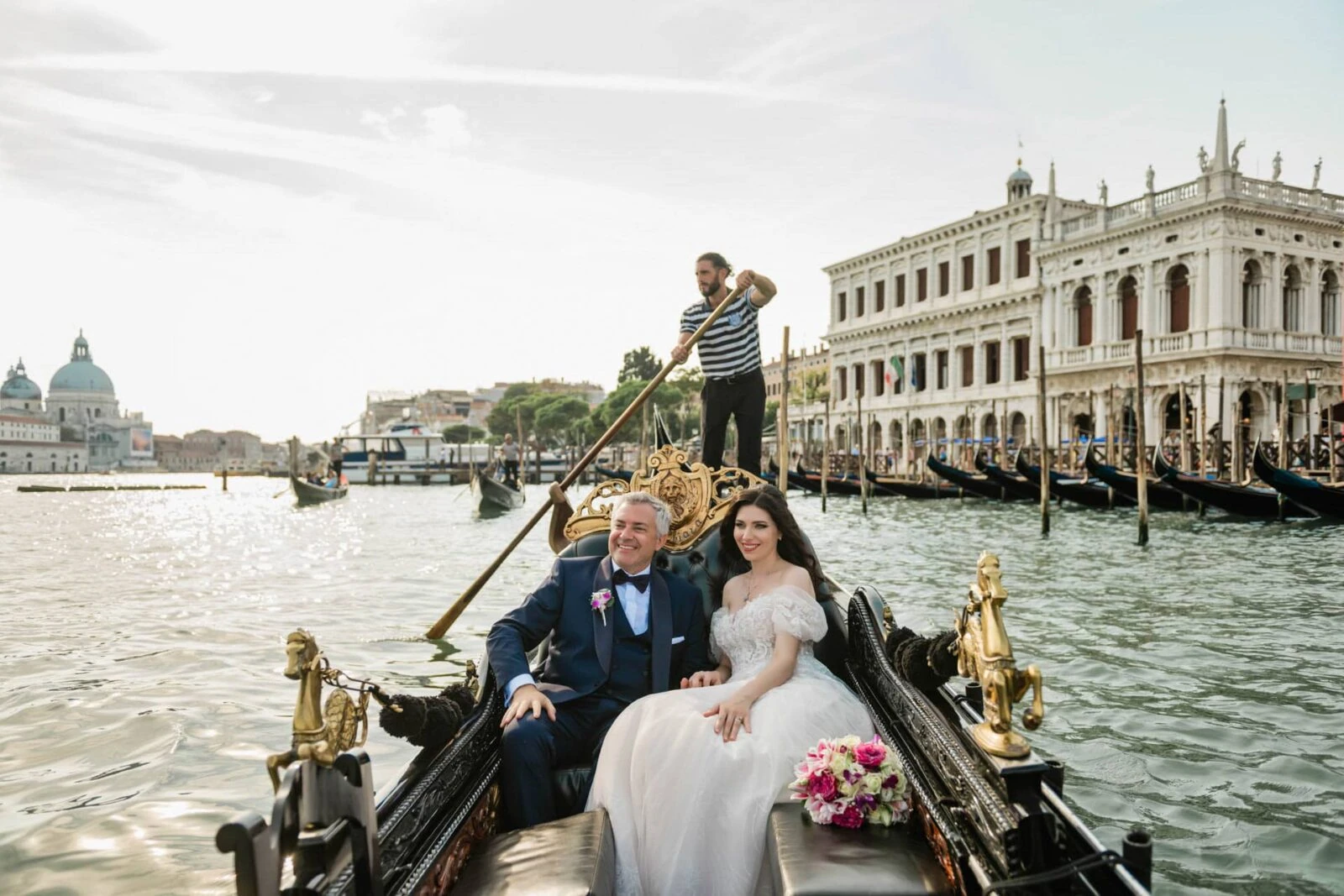 Bride and groom arriving in a private water taxi in Venice.