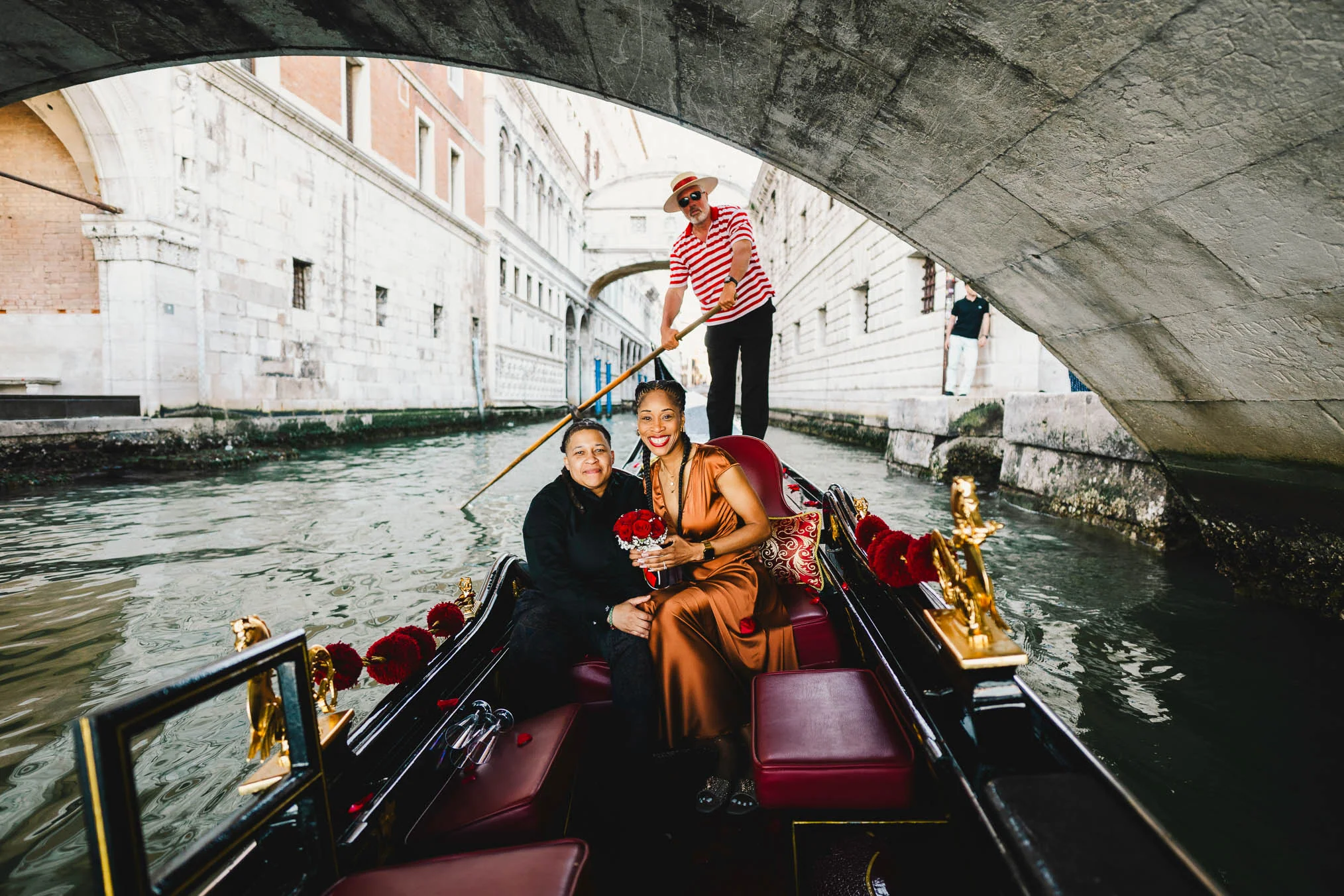 Lesbian proposal in Venice under the Bridge of Sighs in a gondola at sunset