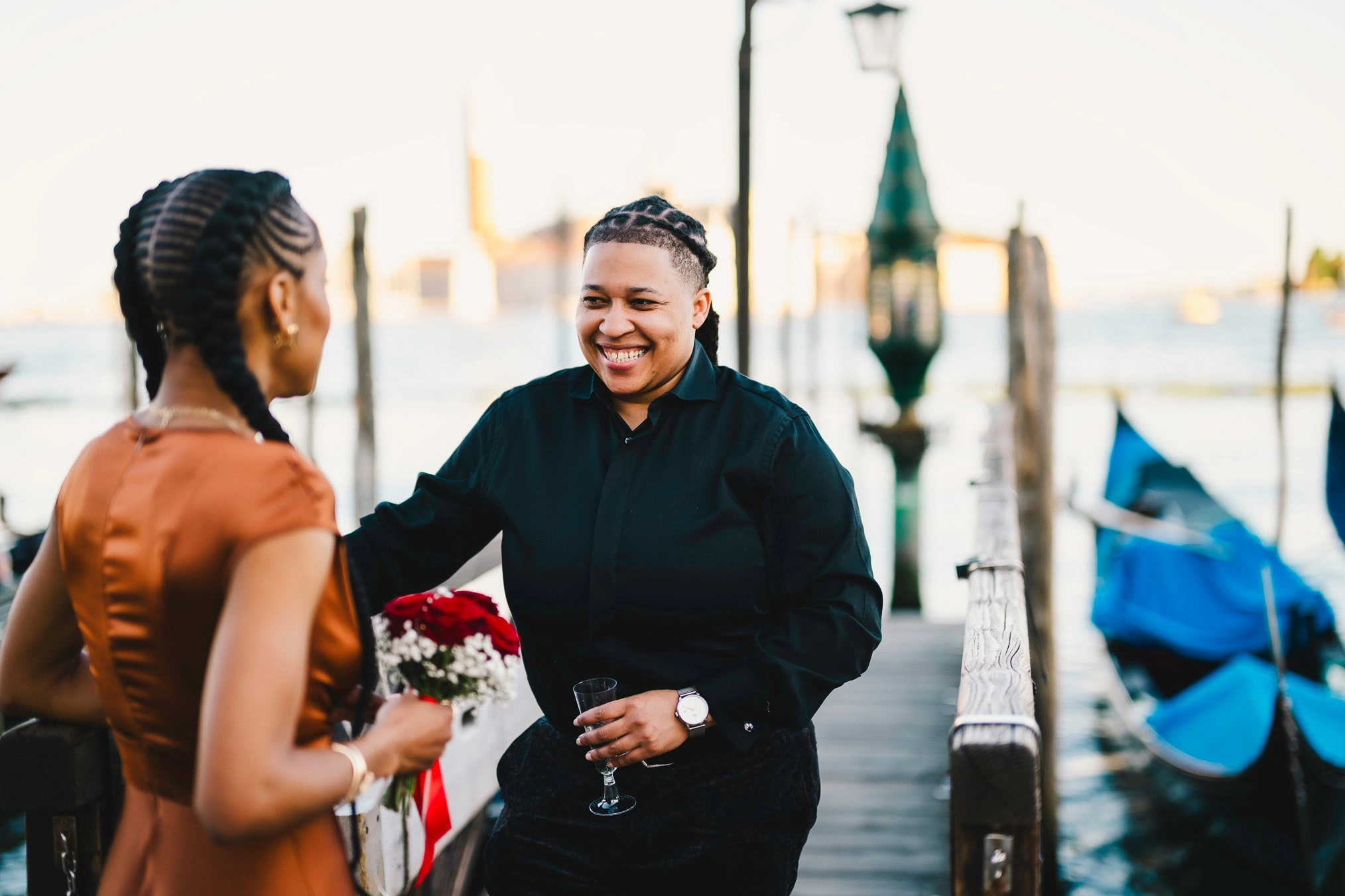 Lesbian couple walking along Riva dei Schiavoni with Grand Canal view in Venice