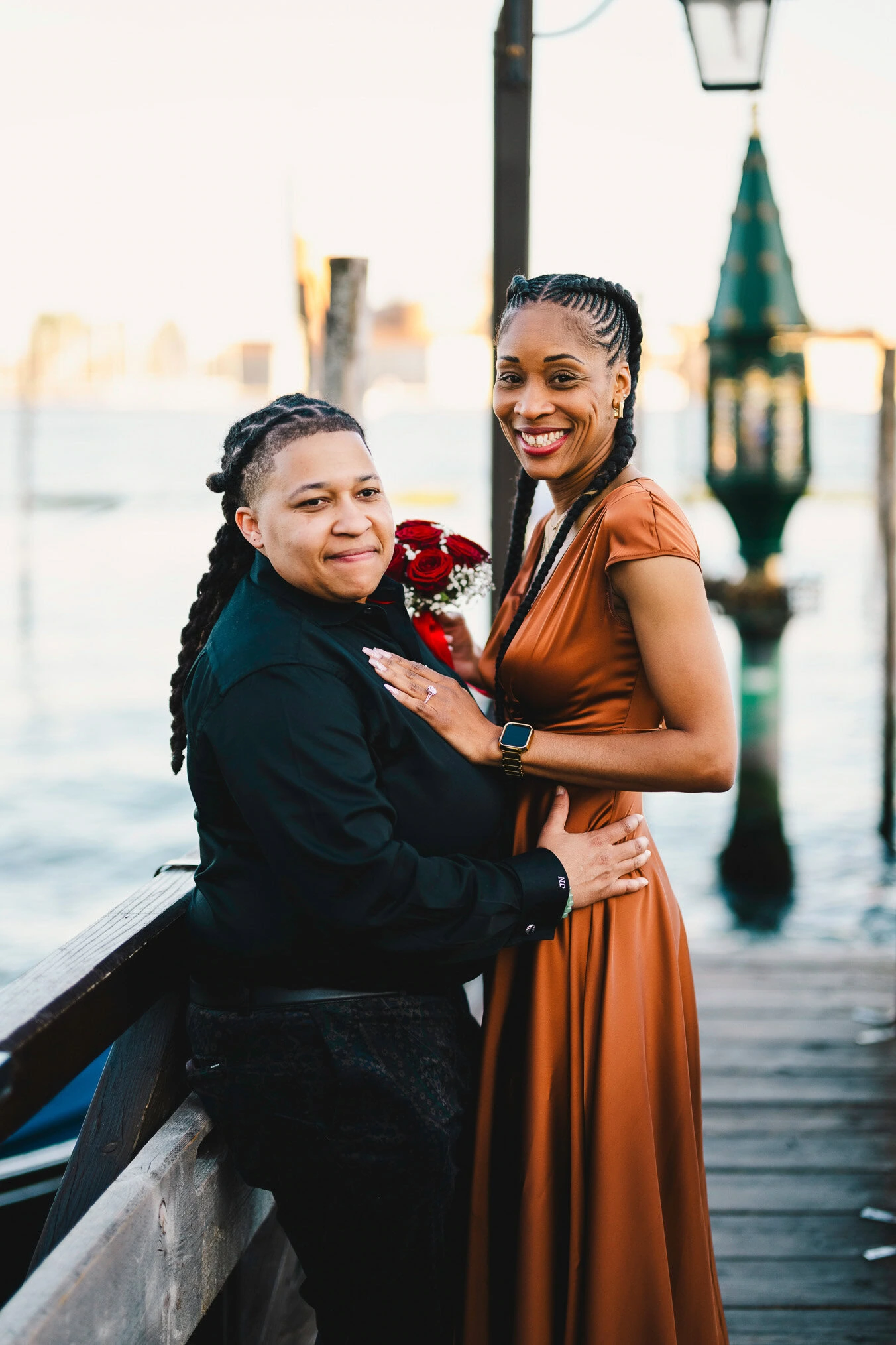 Lesbian couple walking along Riva dei Schiavoni with Grand Canal view in Venice