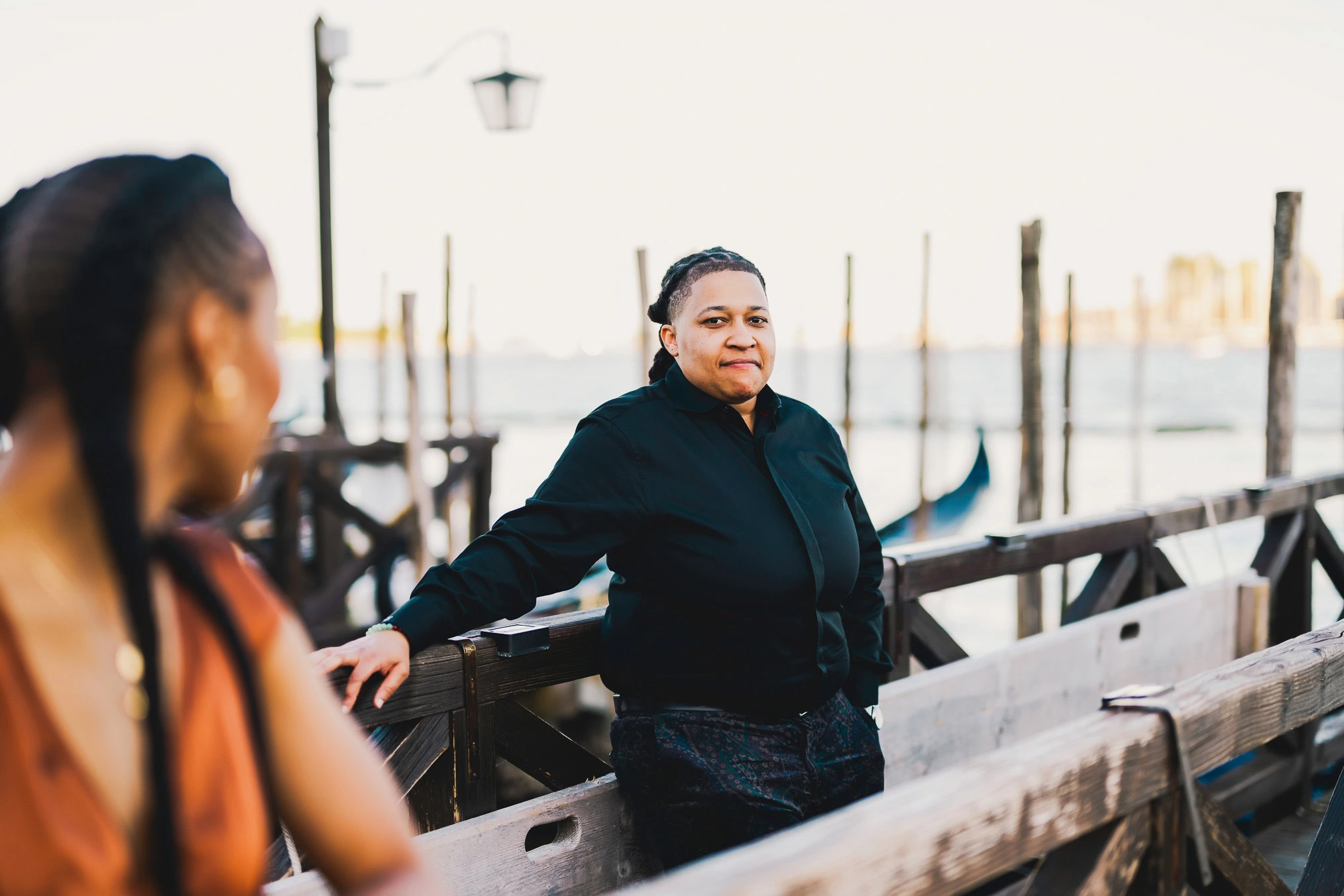 Lesbian couple walking along Riva dei Schiavoni with Grand Canal view in Venice