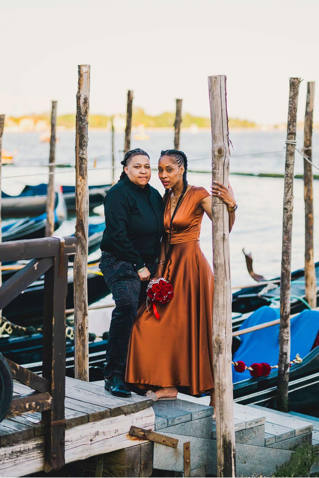Lesbian couple walking along Riva dei Schiavoni with Grand Canal view in Venice