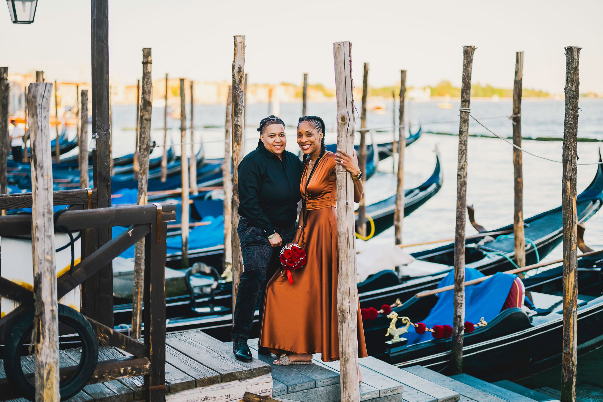 Lesbian couple walking along Riva dei Schiavoni with Grand Canal view in Venice