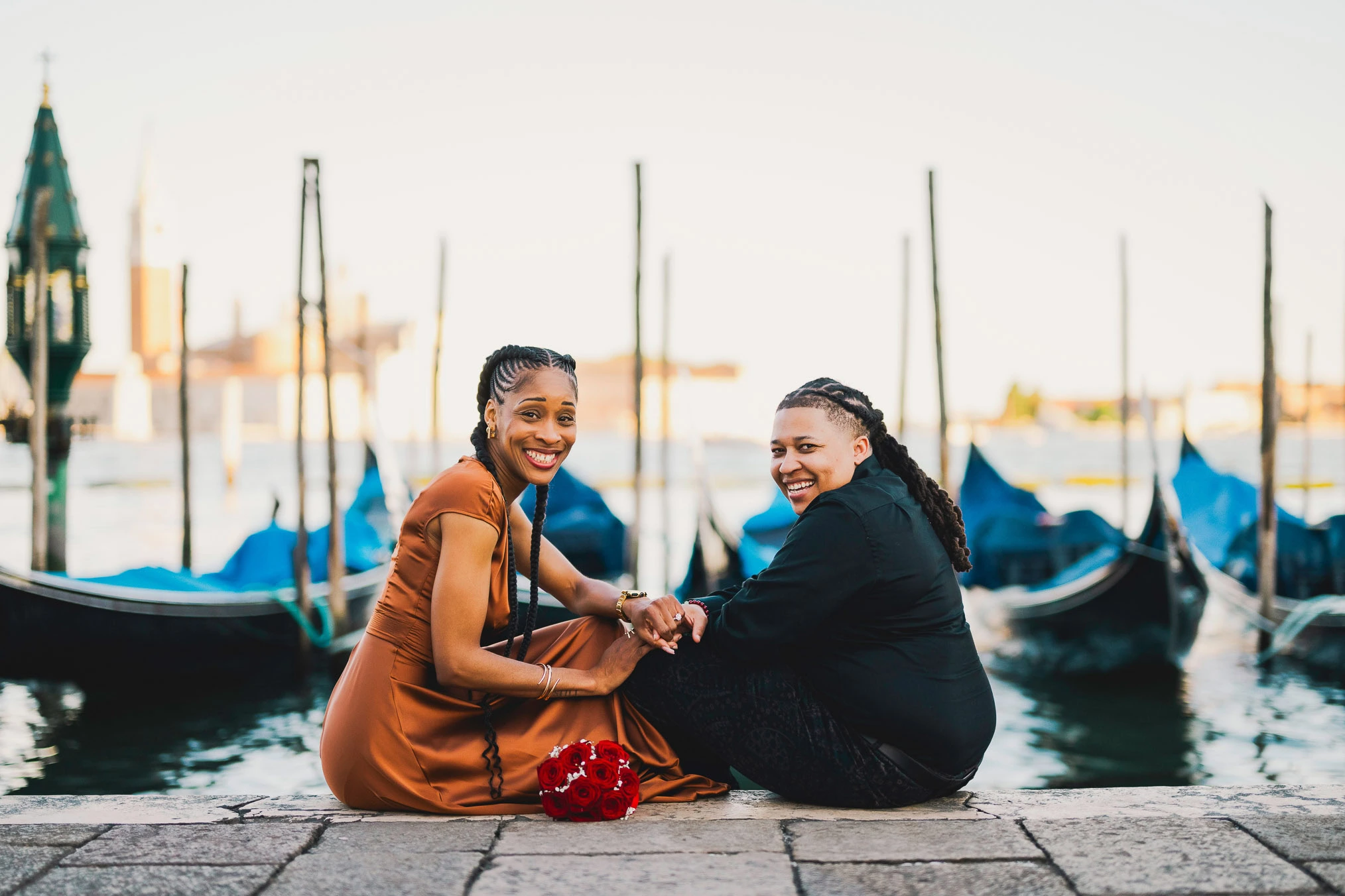 Lesbian couple walking along Riva dei Schiavoni with Grand Canal view in Venice