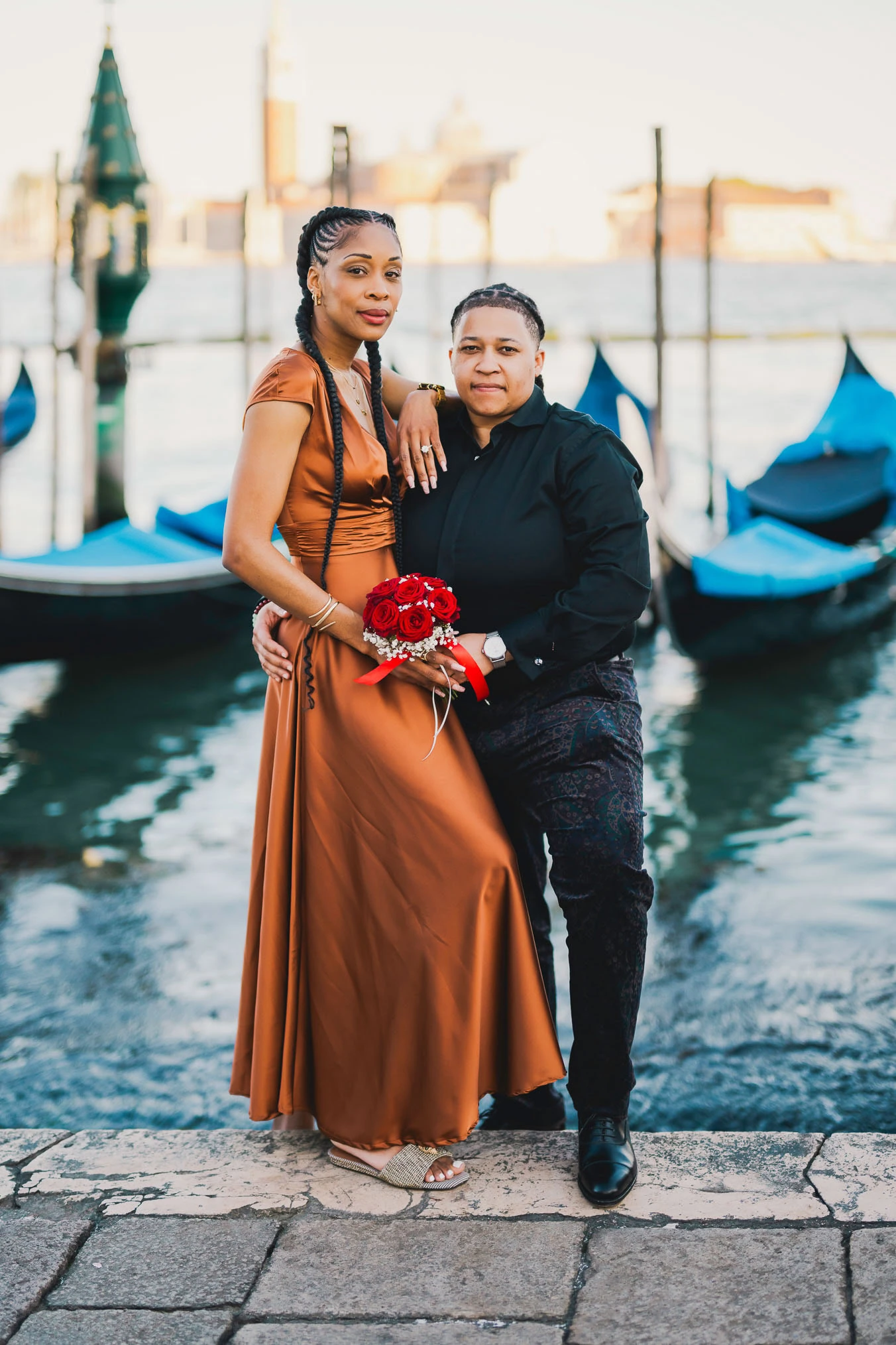 Lesbian couple walking along Riva dei Schiavoni with Grand Canal view in Venice