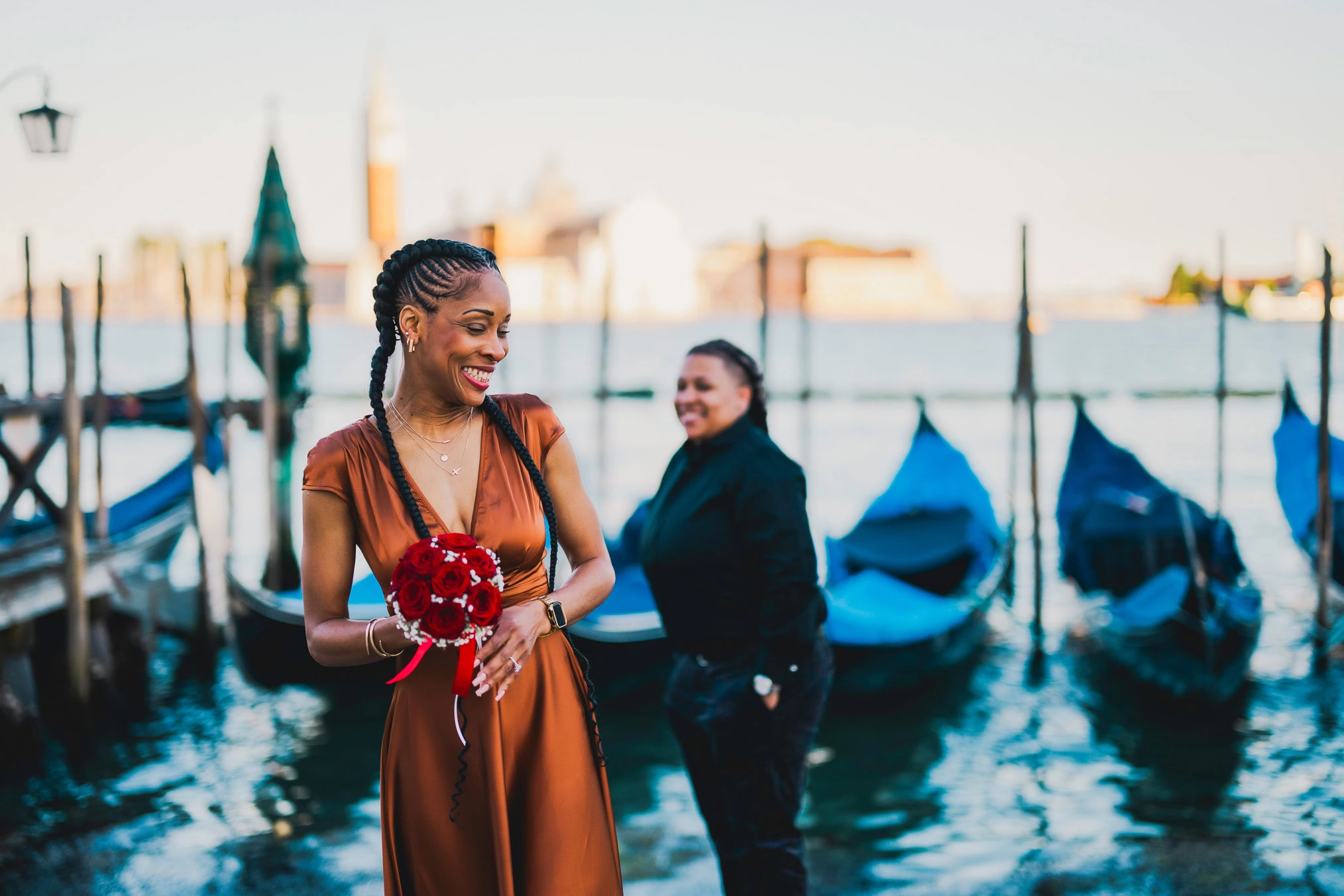 Lesbian couple walking along Riva dei Schiavoni with Grand Canal view in Venice