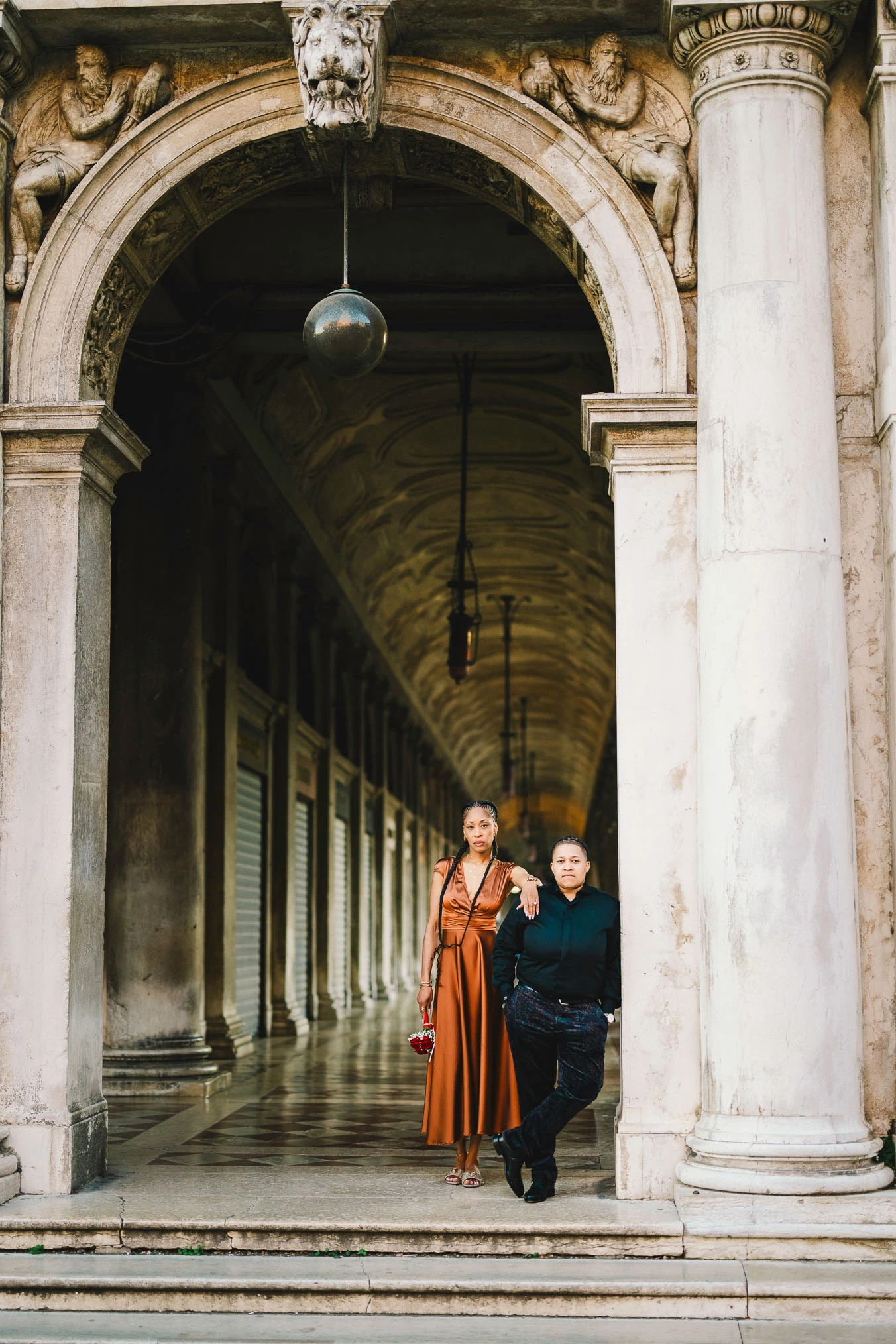 Two women in love under the arcades of San Marco