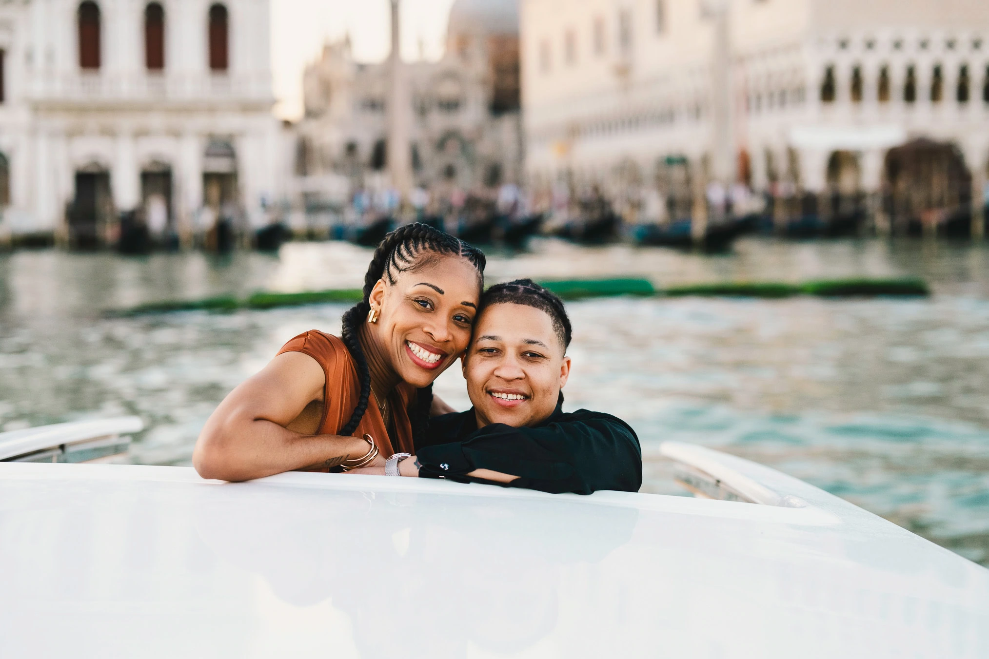 Lesbian couple in a private water taxi on the Grand Canal during their proposal in Venice