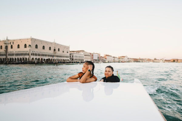Lesbian couple in a private water taxi on the Grand Canal during their proposal in Venice