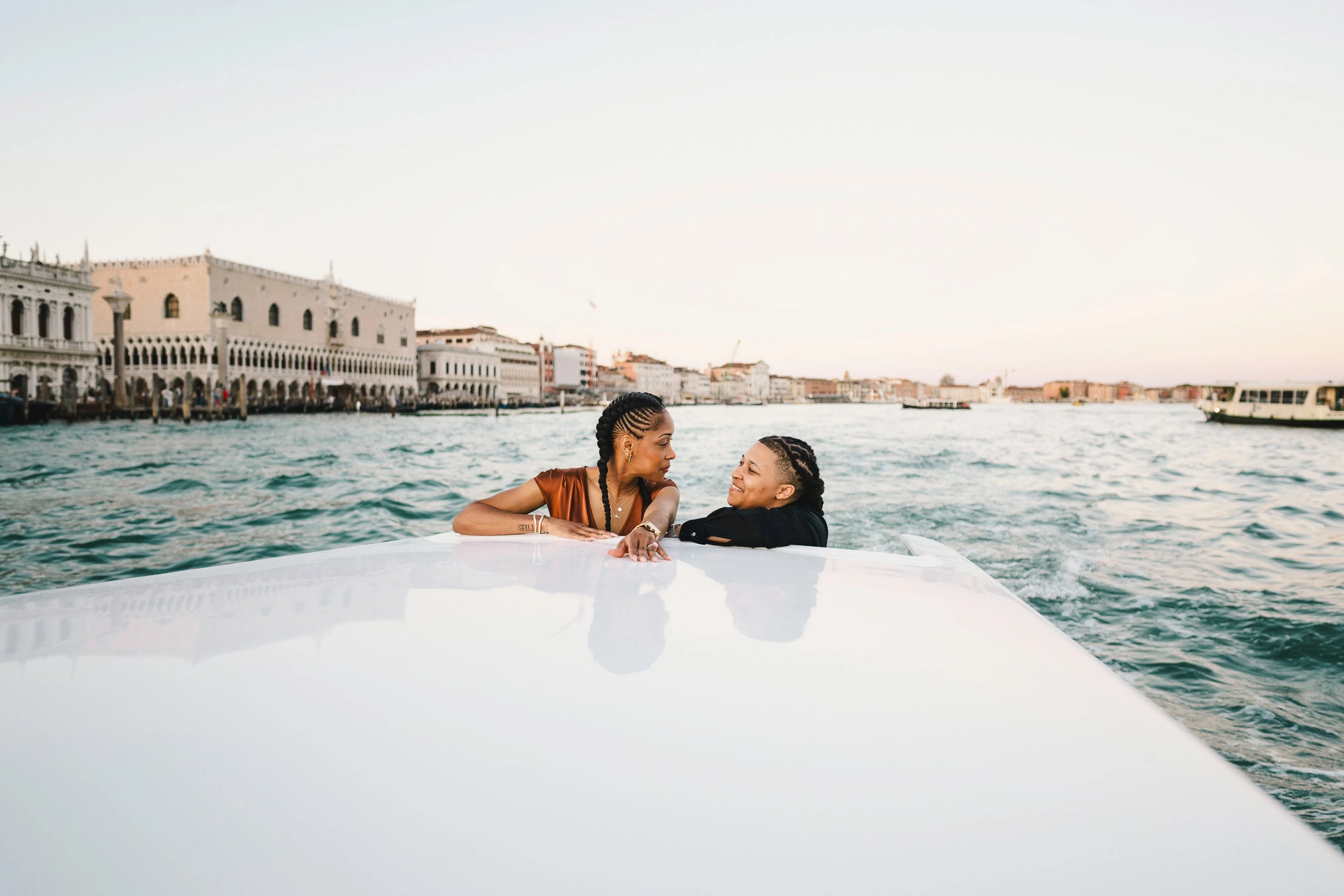 Lesbian couple in a private water taxi on the Grand Canal during their proposal in Venice