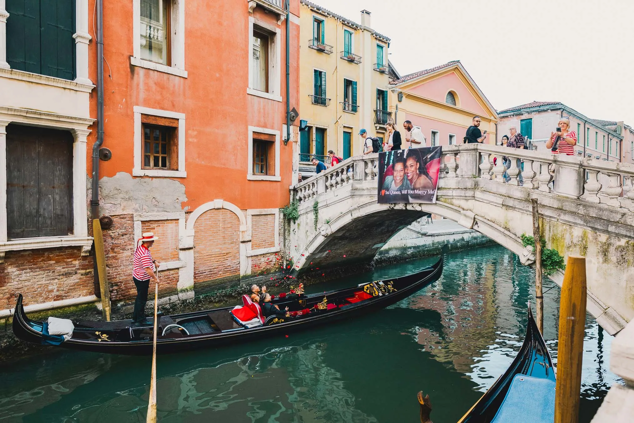 Lesbian proposal in Venice under the Bridge of Sighs in a gondola at sunset