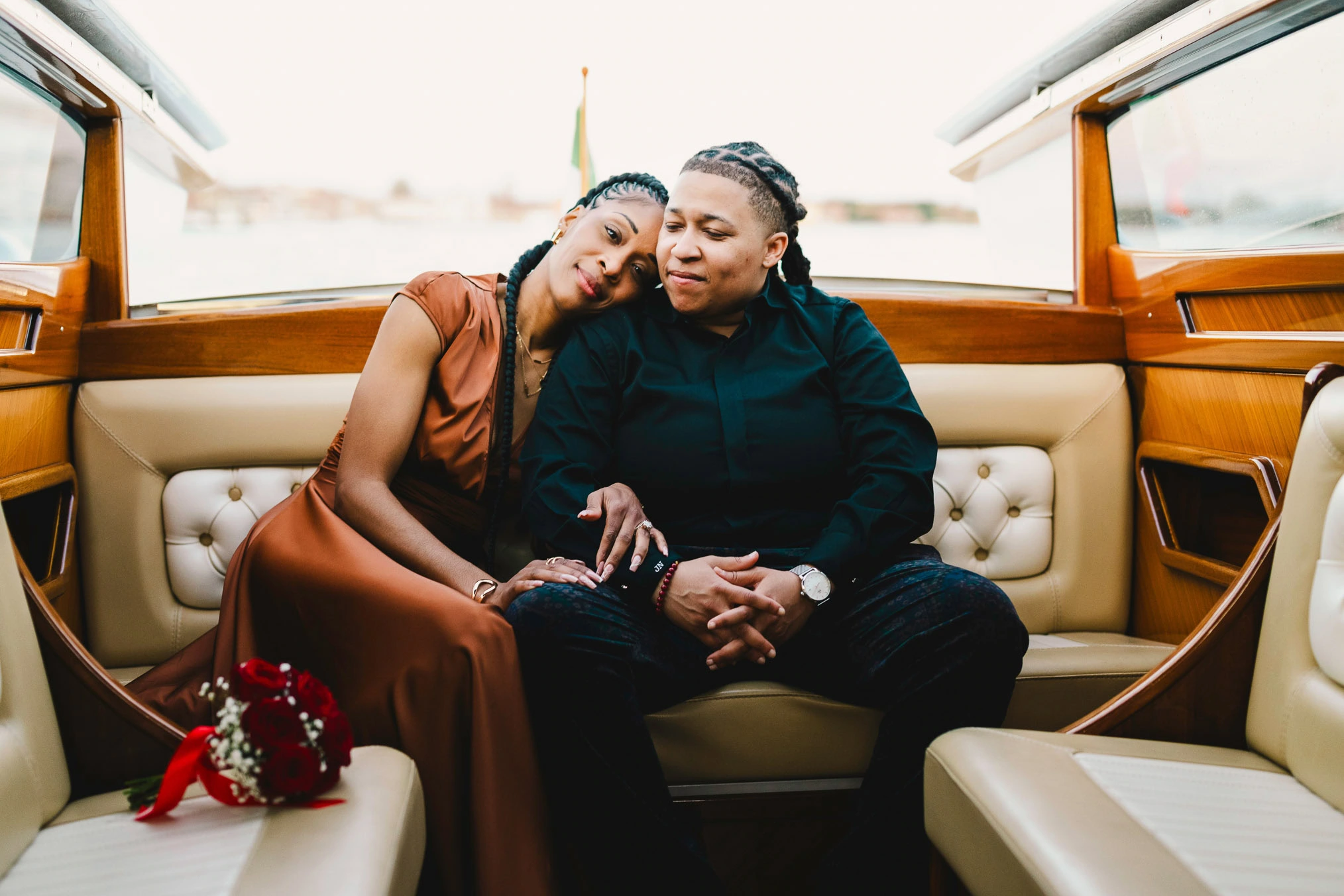 Lesbian couple in a private water taxi on the Grand Canal during their proposal in Venice