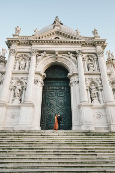 Lesbian couple in front of Santa Maria della Salute during their proposal in Venice