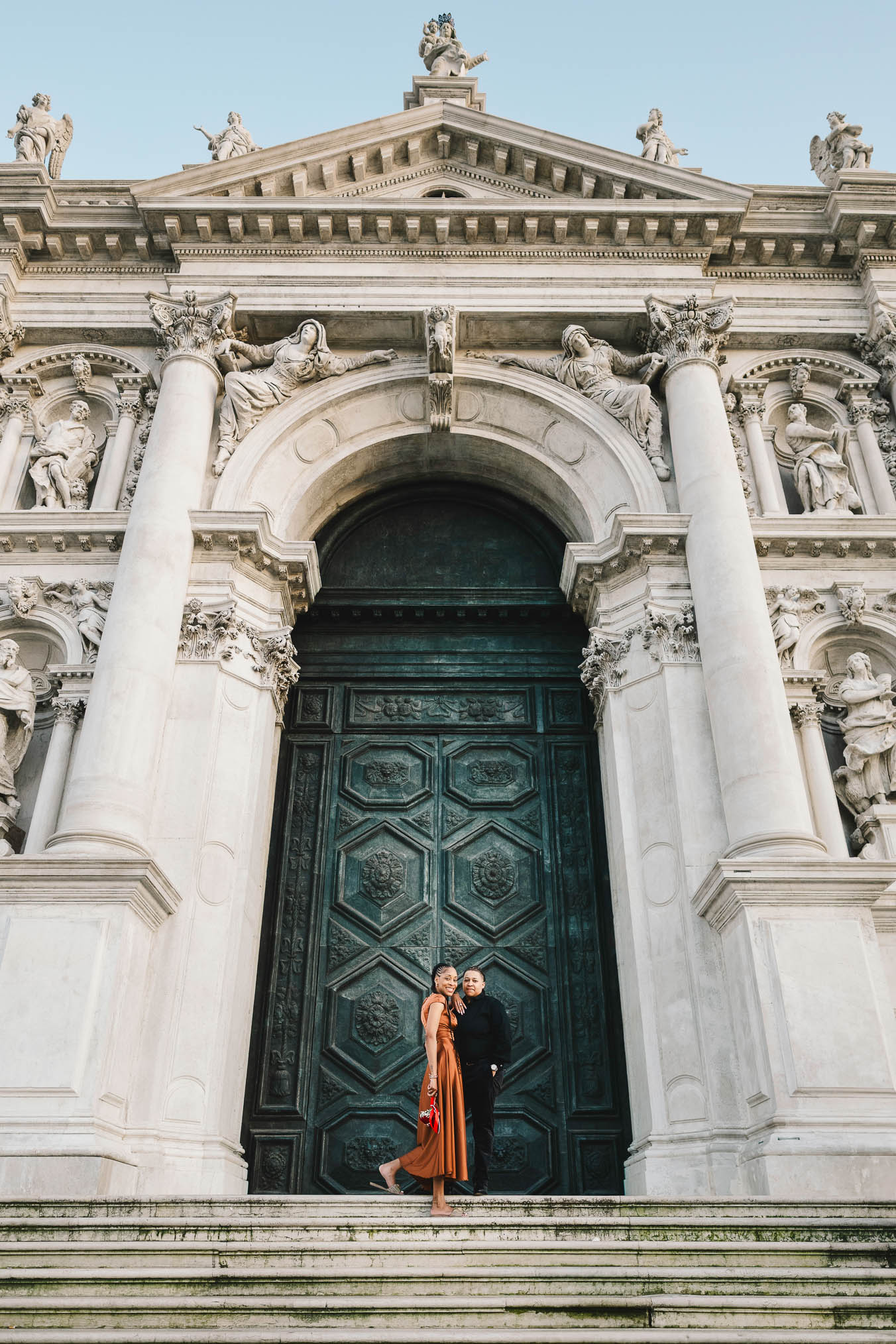 Lesbian couple in front of Santa Maria della Salute during their proposal in Venice