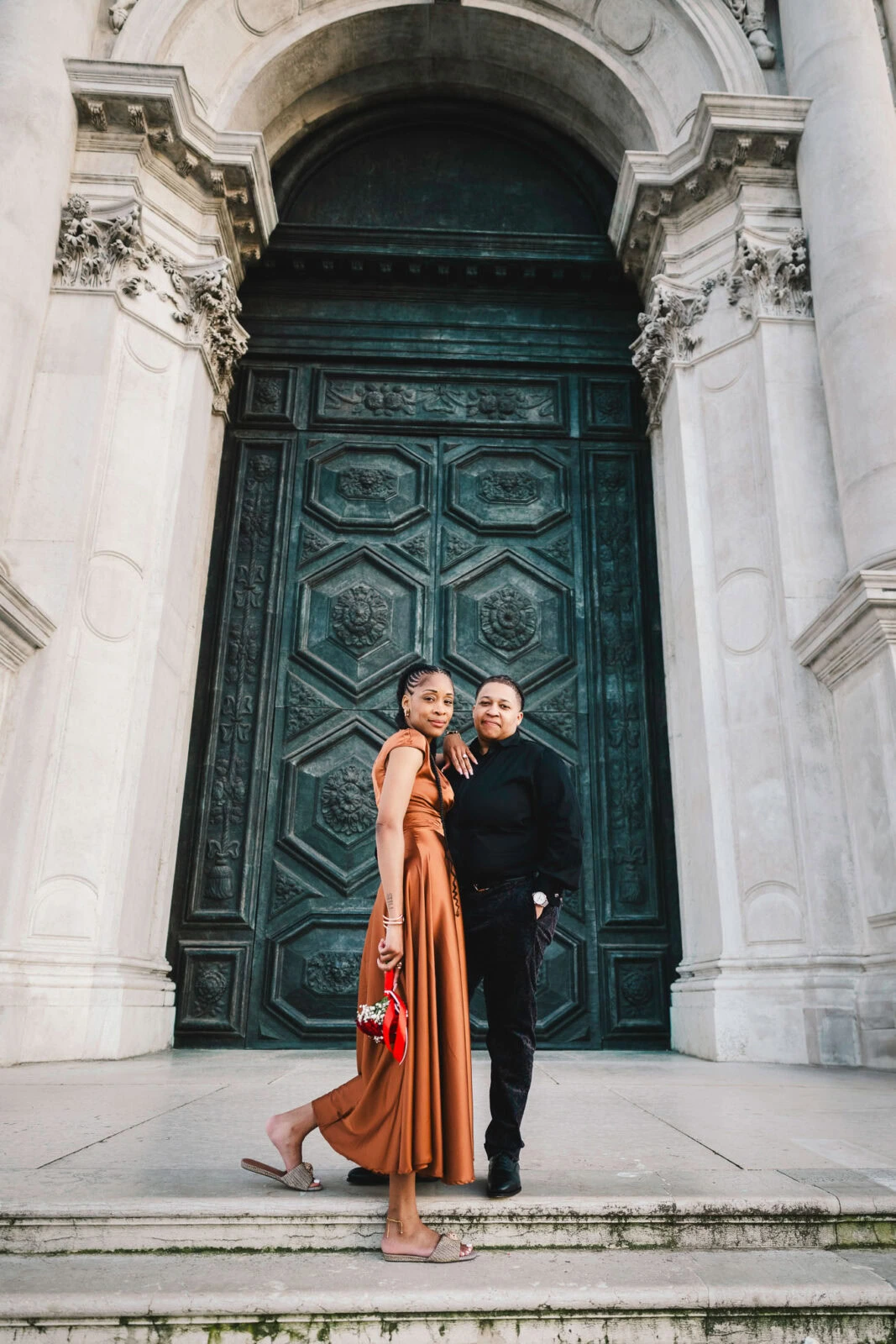 Lesbian couple in front of Santa Maria della Salute during their proposal in Venice