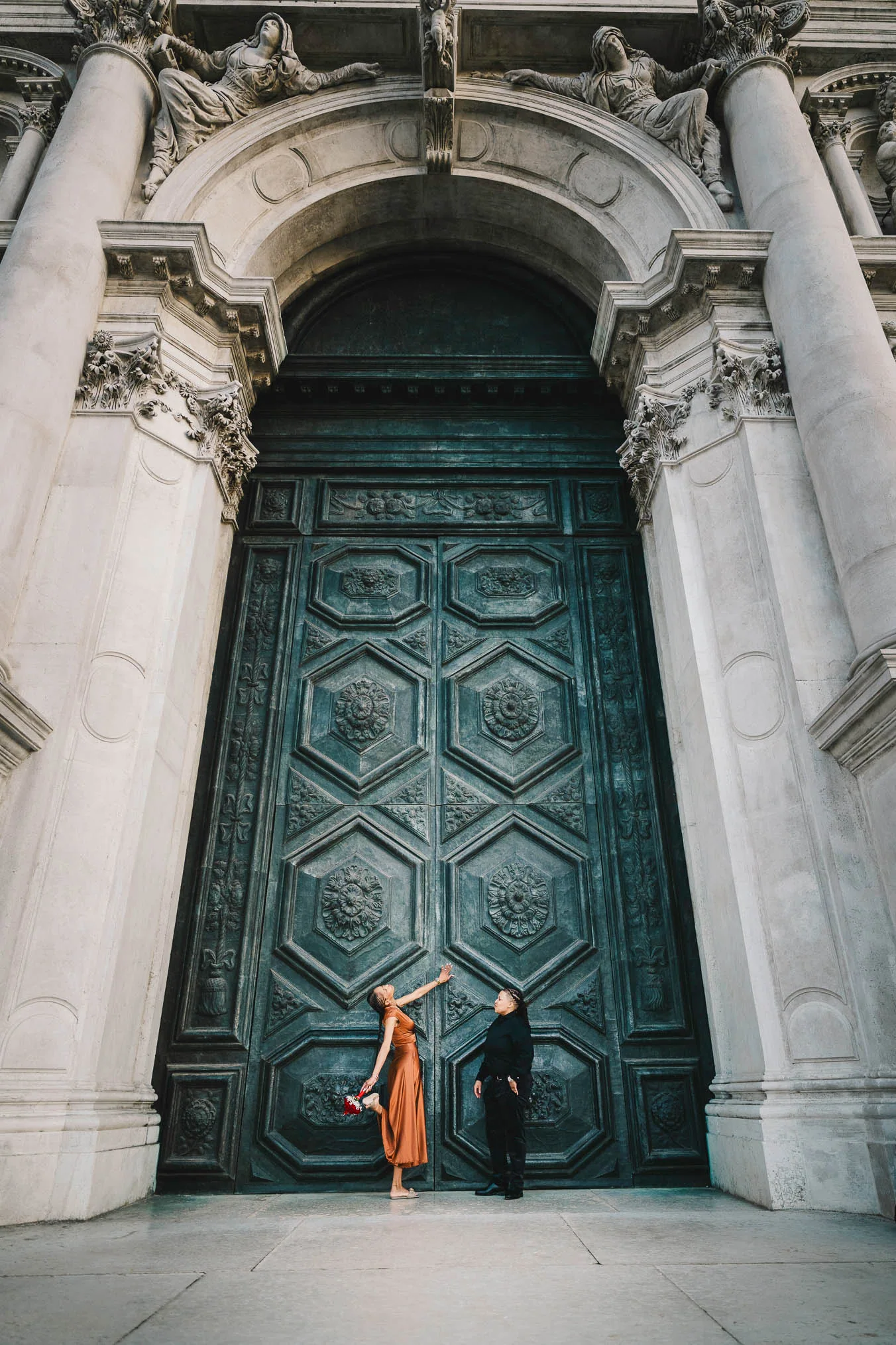 Lesbian couple in front of Santa Maria della Salute during their proposal in Venice
