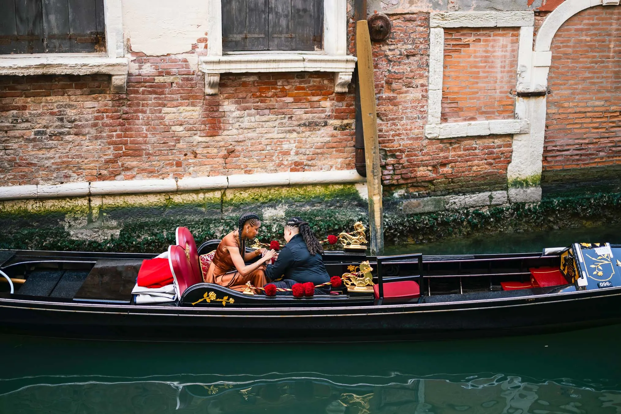 Lesbian proposal in Venice under the Bridge of Sighs in a gondola at sunset
