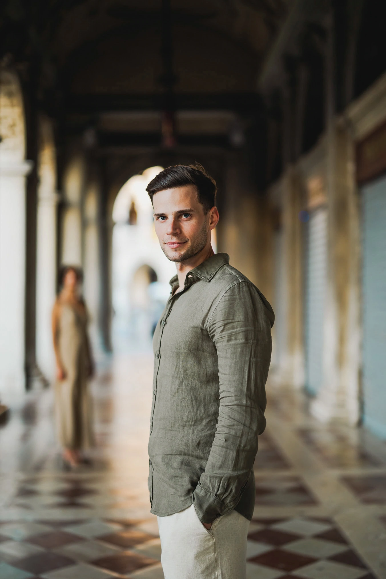 Engaged couple standing under the historic arches of San Marco