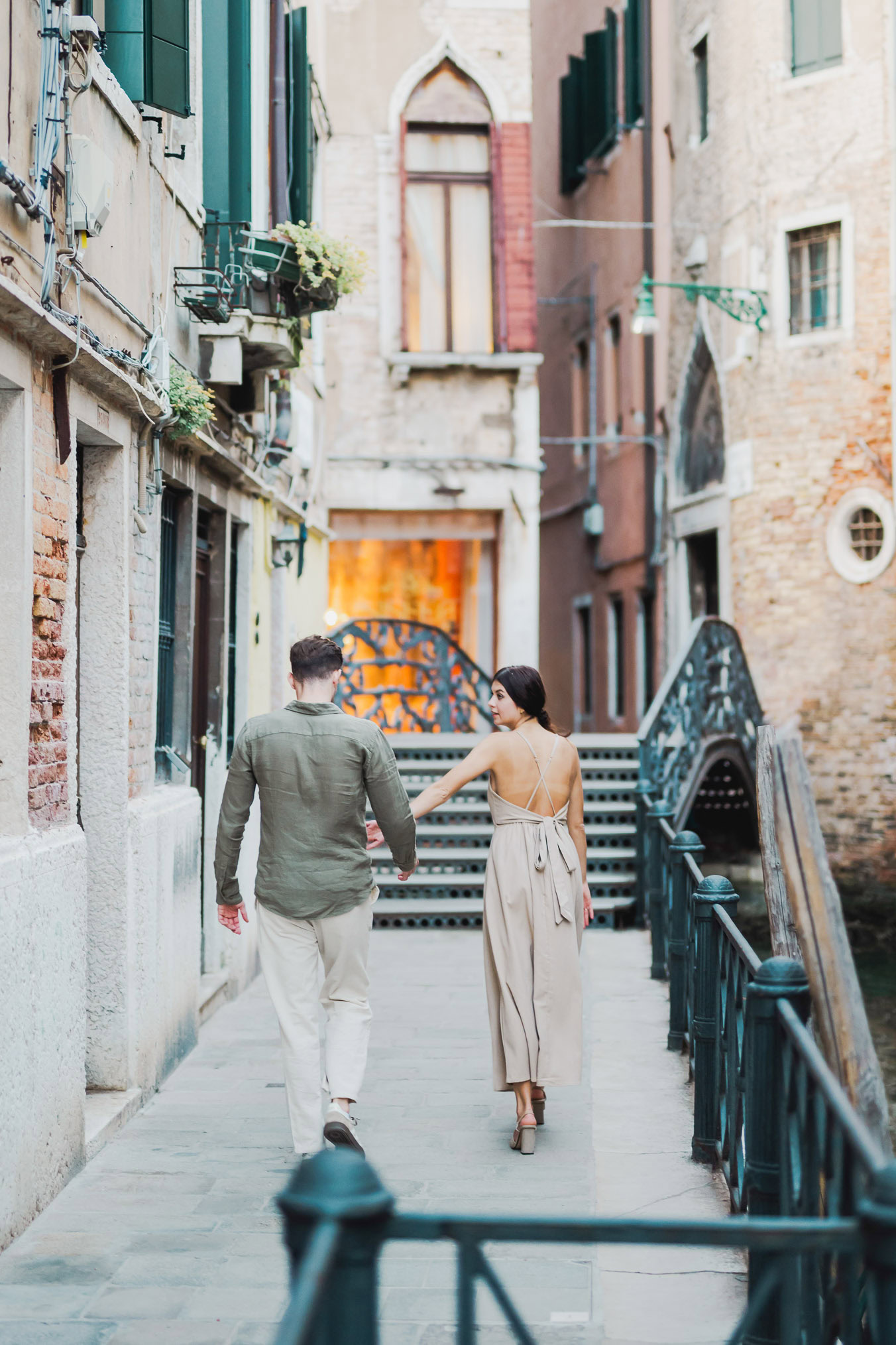 Couple sharing a private moment beside a Venetian canal
